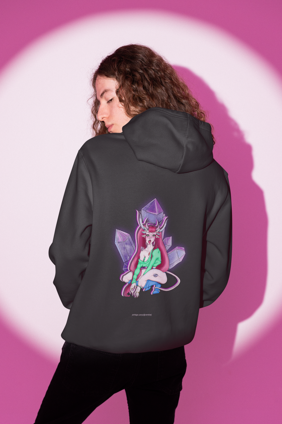 Heart Thief Heavyweight Hoodie in Black, worn by a man seen from behind in a studio under pink light, showing the large print on the back. Digital product mockup.