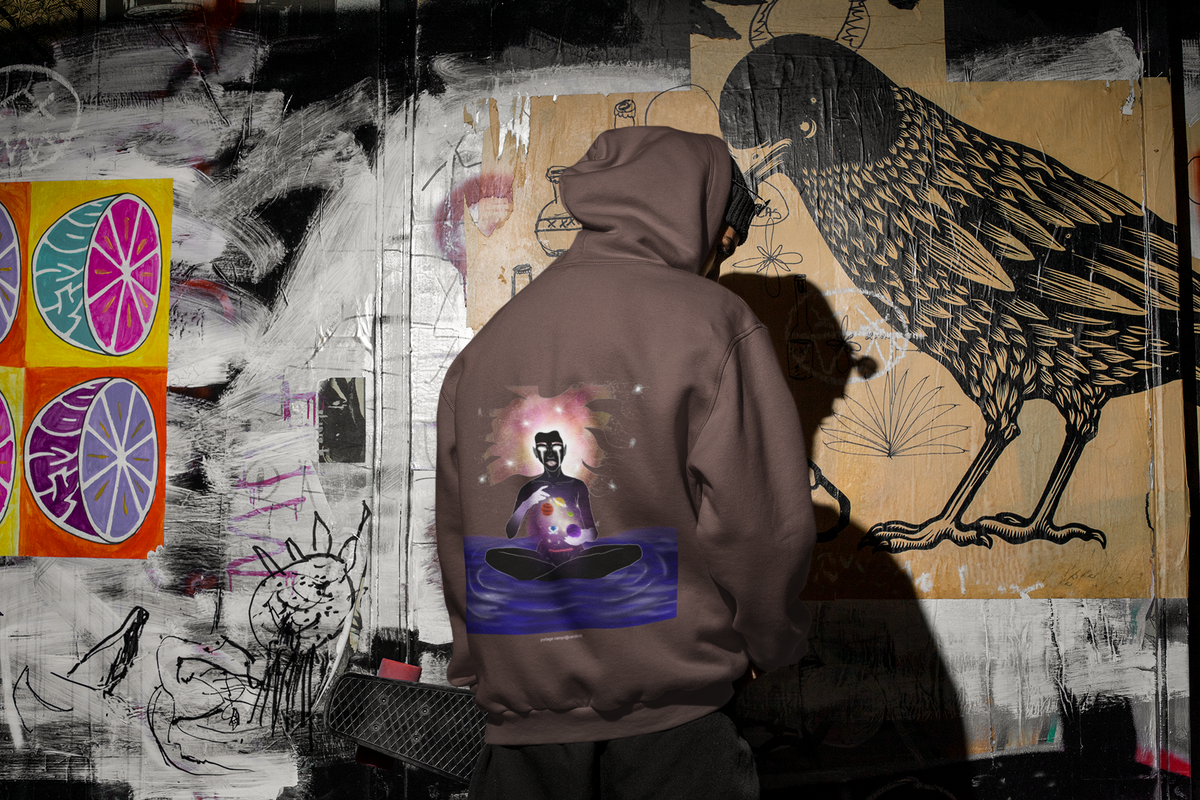Orbit Keeper Heavyweight Hoodie in Brown, worn by a man seen from behind in a dark alley, showing the large print on the back. Digital product mockup.