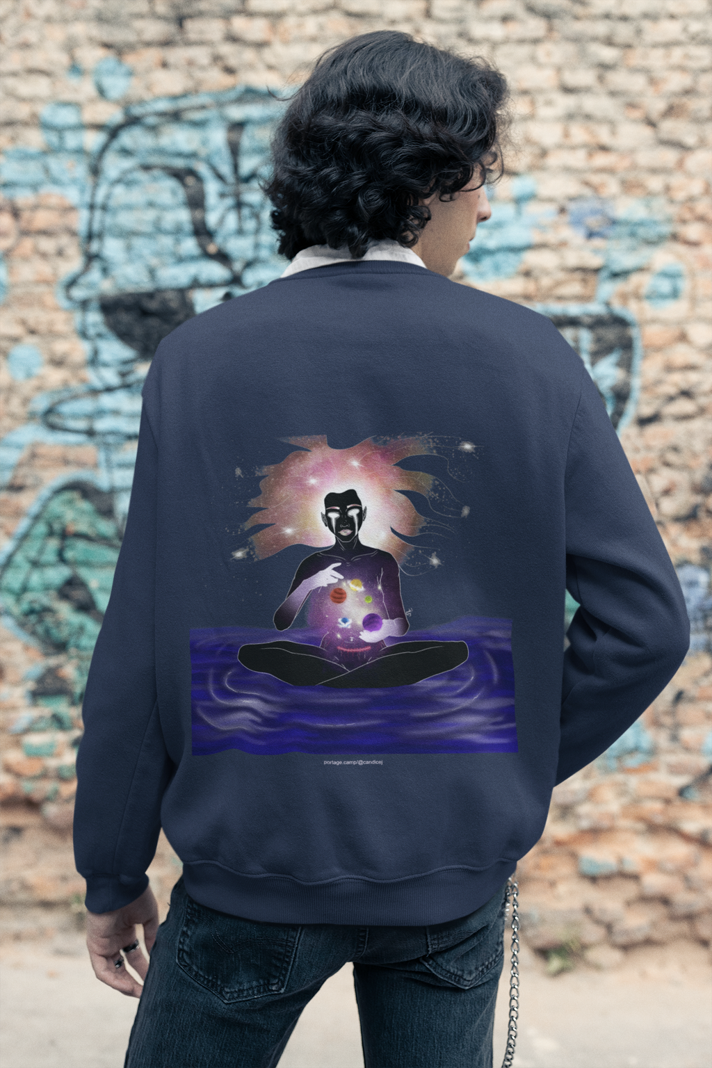 Orbit Keeper Garment-Dyed Crewneck in True Navy, worn by a man seen from behind in a studio, showing the large print on the back. Digital product mockup.
