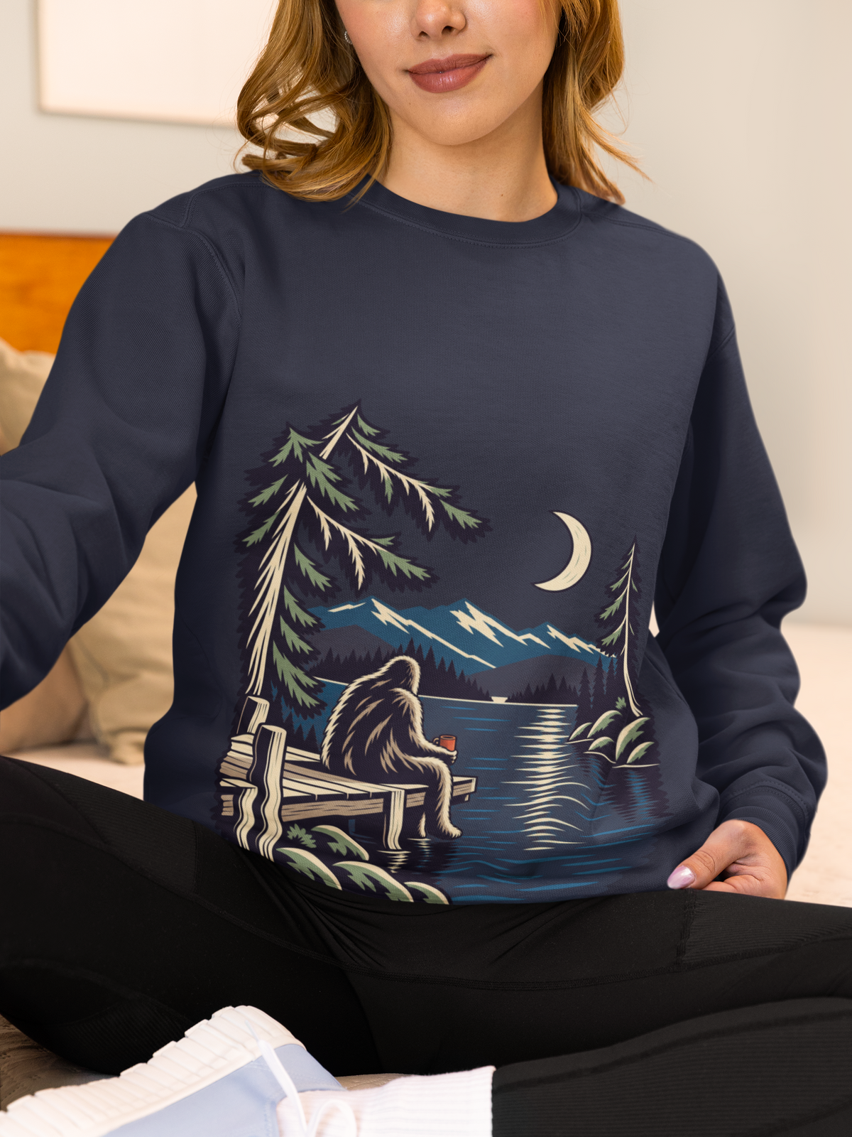 Quiet Hours Garment-Dyed Crewneck (Front Print) in True Navy, worn by a woman at home, showing the large print on the front. Digital product mockup.