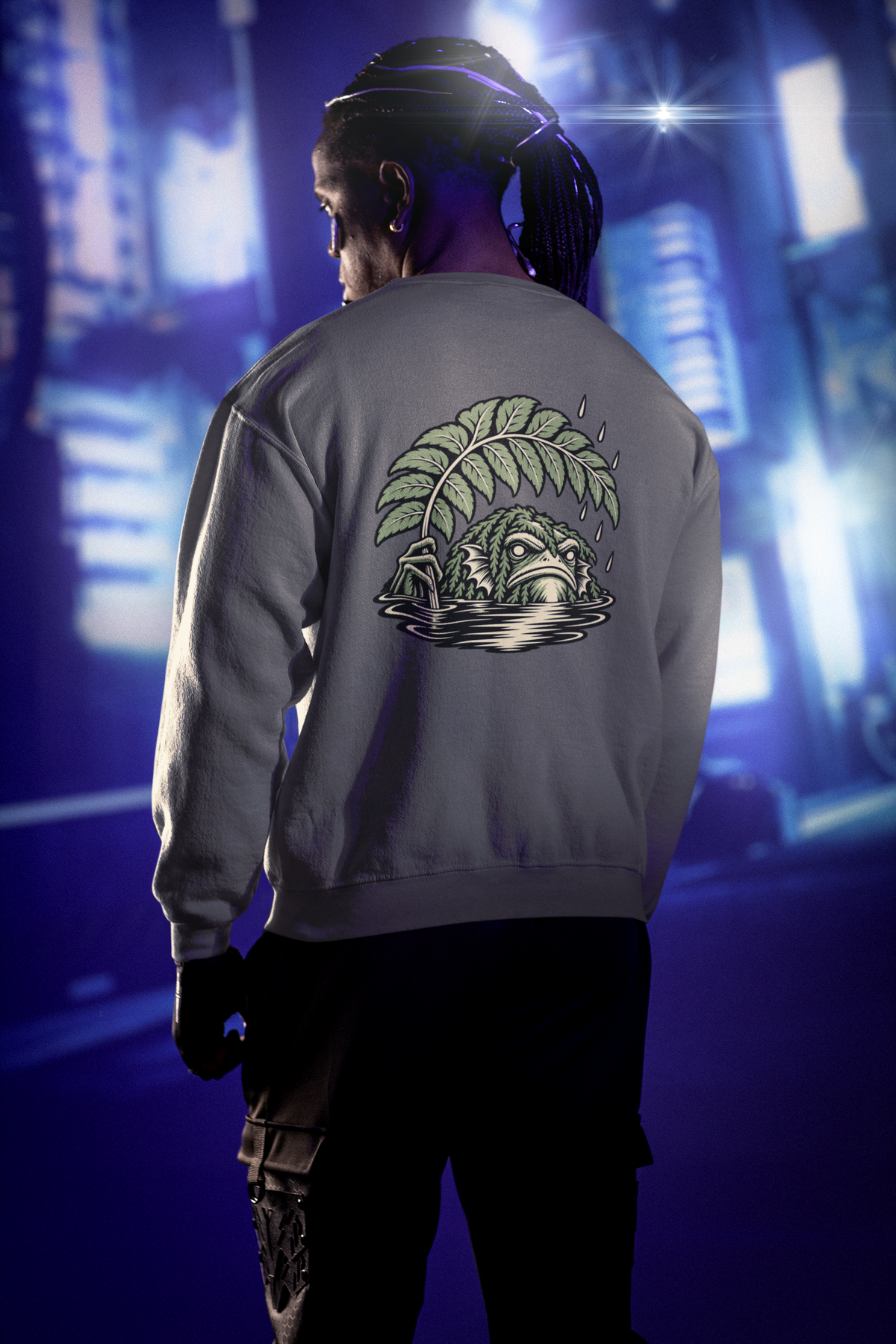 Rain Check Garment-Dyed Crewneck in Pepper, worn by a man seen from behind under neon city lights, showing the large print on the back. Digital product mockup.