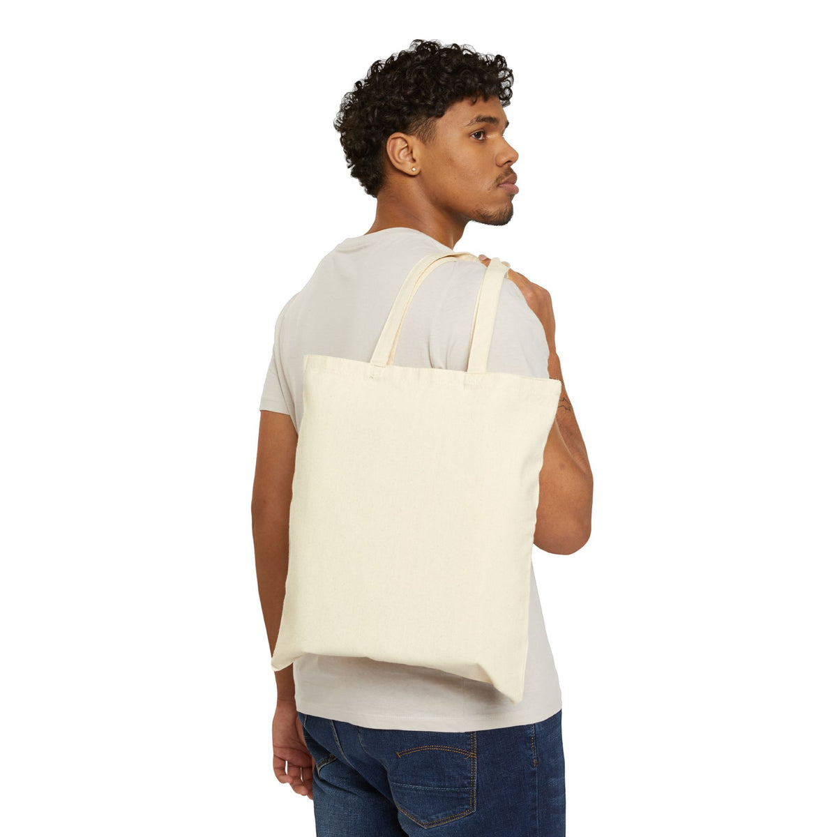 Stay for the Sky canvas tote carried on a shoulder, unprinted back facing outward. Digital product mockup.