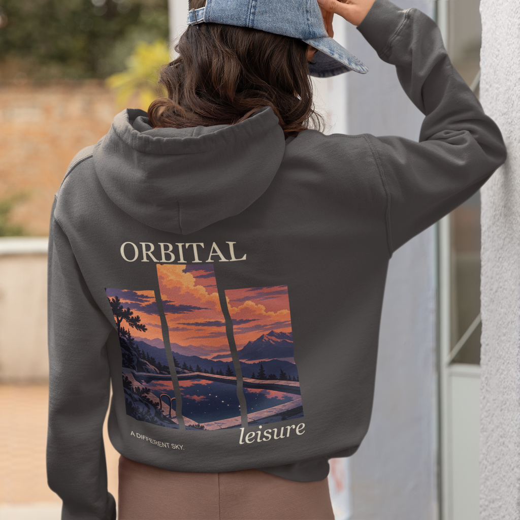 A Different Sky Zip Hoodie in Dark Heather, worn by a woman seen from behind at home, showing the large print on the back. Digital product mockup.