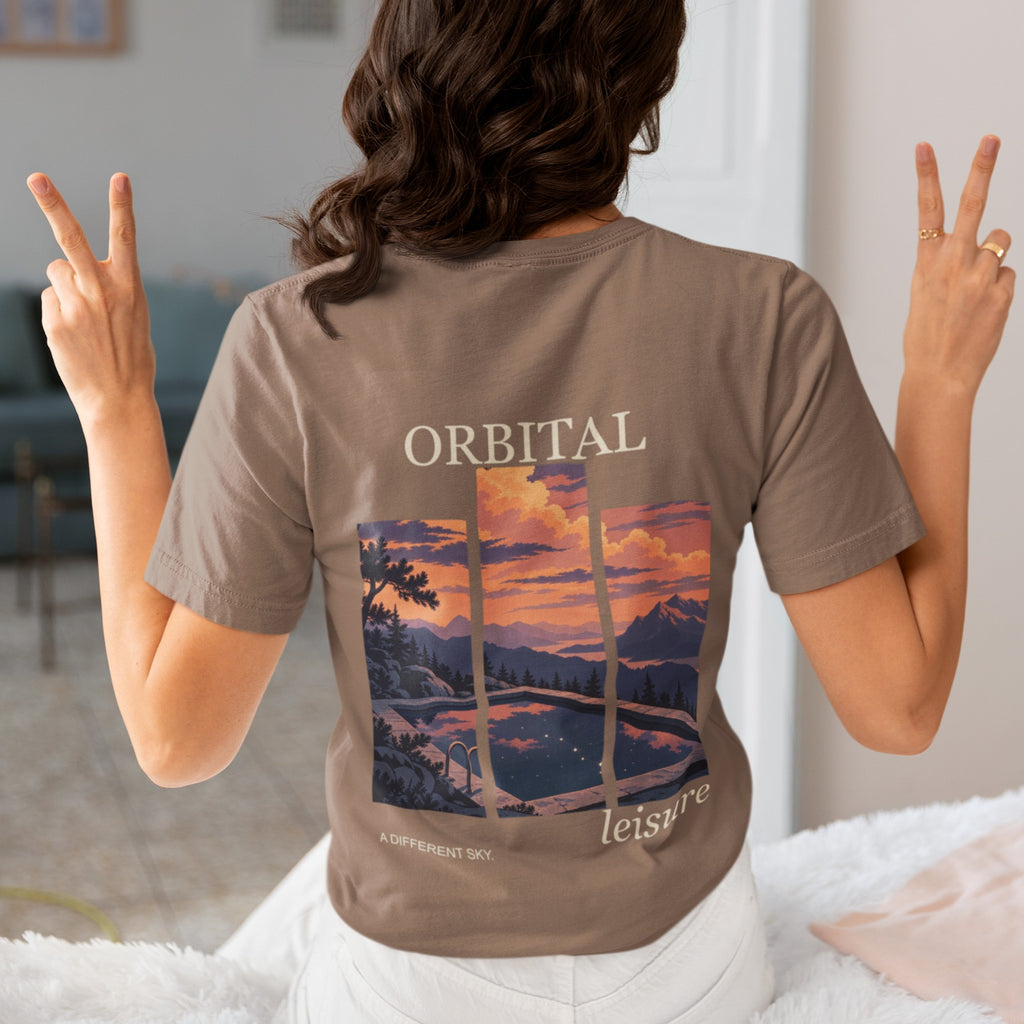 A Different Sky Garment-Dyed Tee in Espresso, worn by a woman seen from behind making peace signs, showing the large print on the back. Digital product mockup.