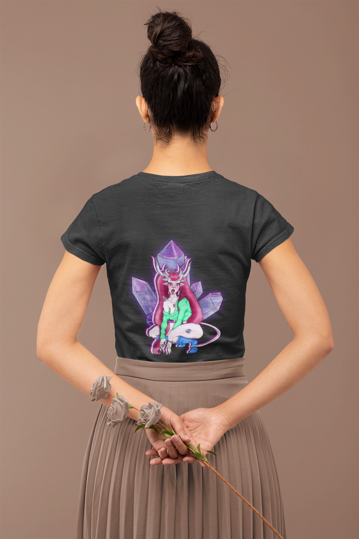 Heart Thief Garment-Dyed Tee in Black, worn by a woman seen from behind holding flowers, showing the large print on the back. Digital product mockup.