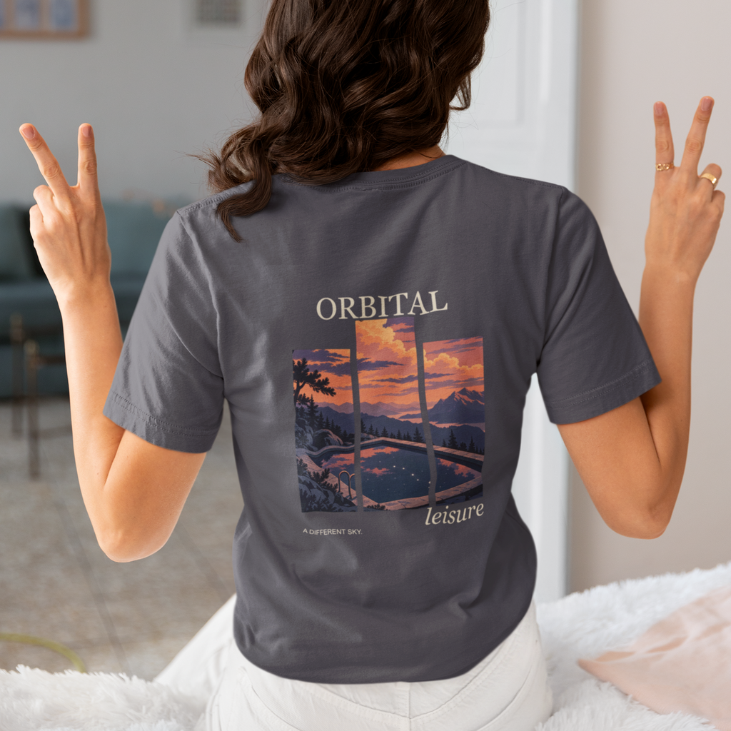 A Different Sky Garment-Dyed Tee in Navy, worn by a woman seen from behind making peace signs, showing the large print on the back. Digital product mockup.