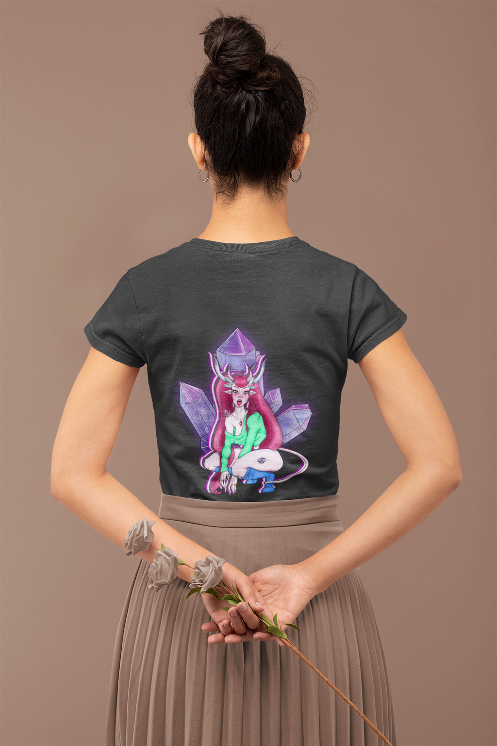 Heart Thief Women’s Relaxed Tee in Black, worn by a woman seen from behind holding flowers, showing the large print on the back. Digital product mockup.