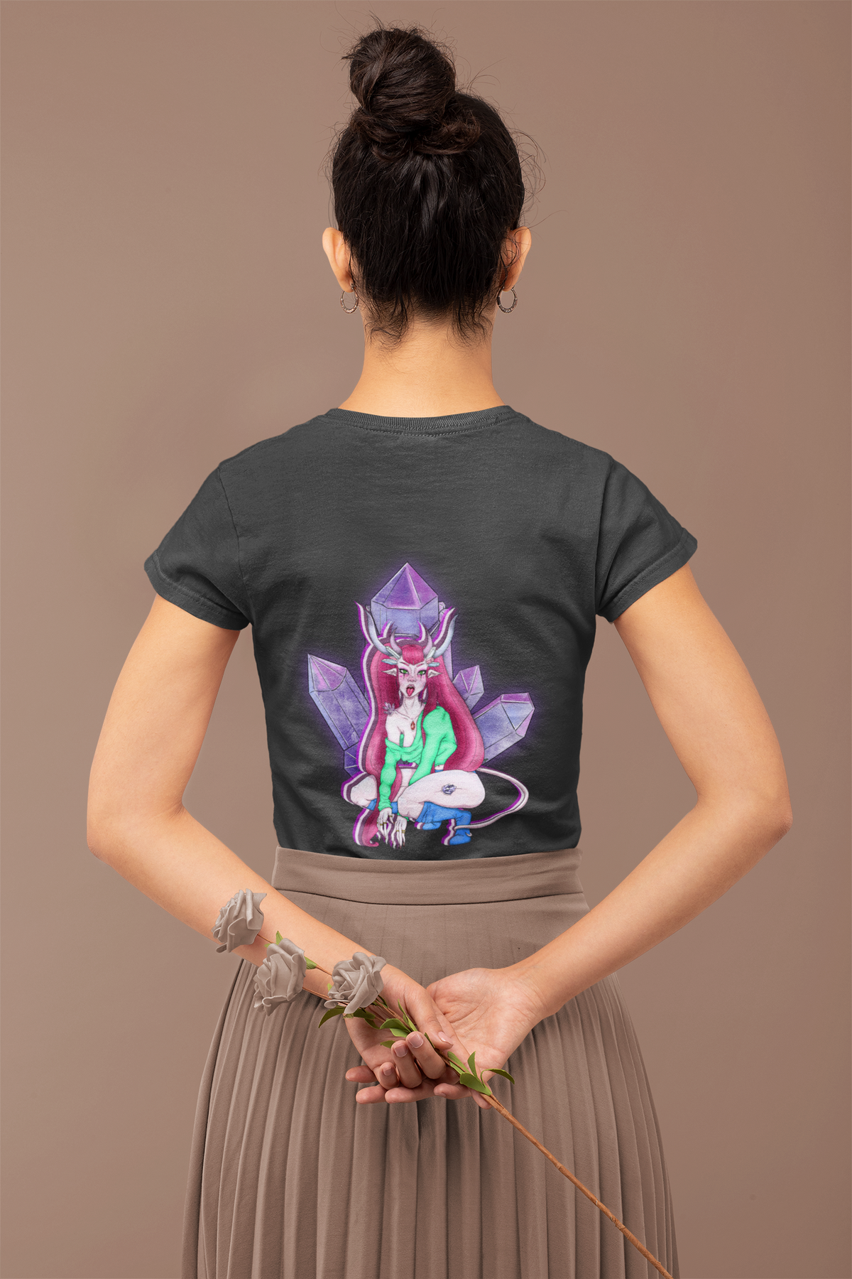 Heart Thief Women’s Relaxed Tee in Black, worn by a woman seen from behind holding flowers, showing the large print on the back. Digital product mockup.