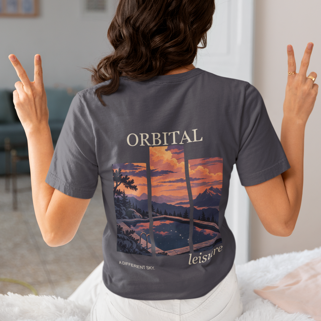 A Different Sky Garment-Dyed Tee in Navy, worn by a woman seen from behind making peace signs, showing the large print on the back. Digital product mockup.
