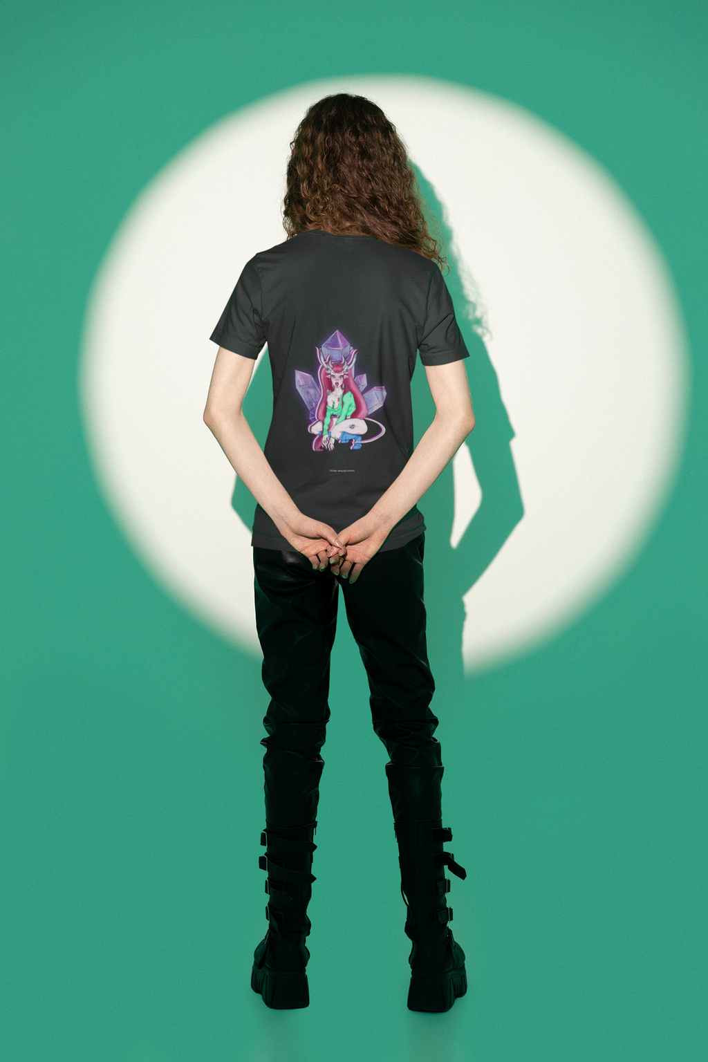 Heart Thief Garment-Dyed Tee in Black, worn by a man seen from behind in a studio under green light, showing the large print on the back. Digital product mockup.