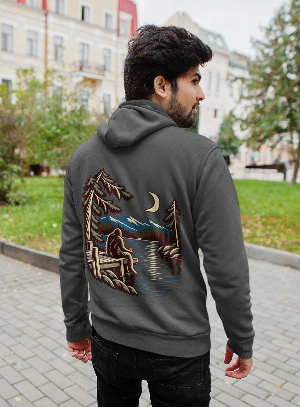 Quiet Hours Zip Hoodie in Dark Heather, worn by a man seen from behind on a quiet city street, showing the large print on the back. Digital product mockup.