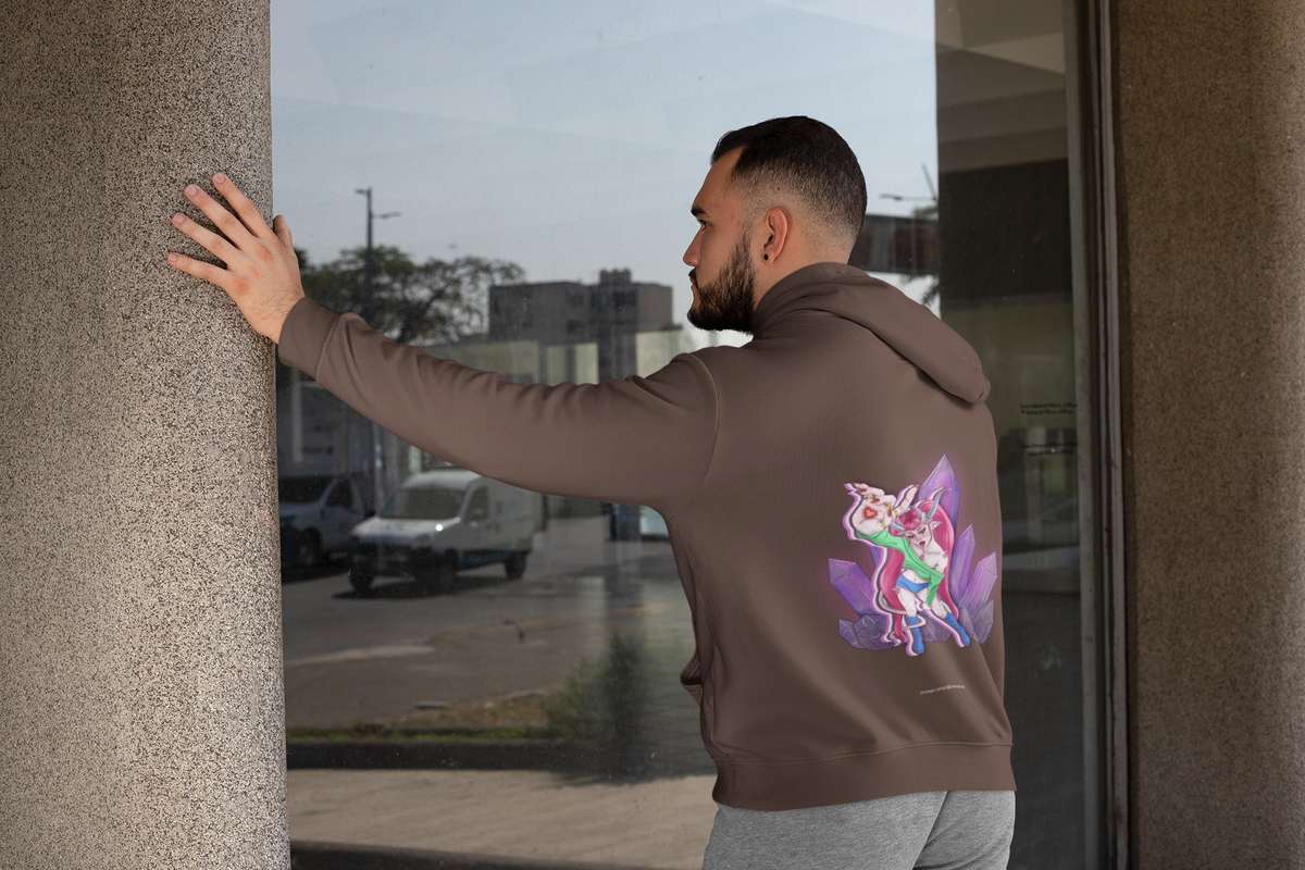Rain Check Heavyweight Hoodie in Brown, worn by a man seen from behind leaning on a pillar by a window, showing the large print on the back. Digital product mockup.