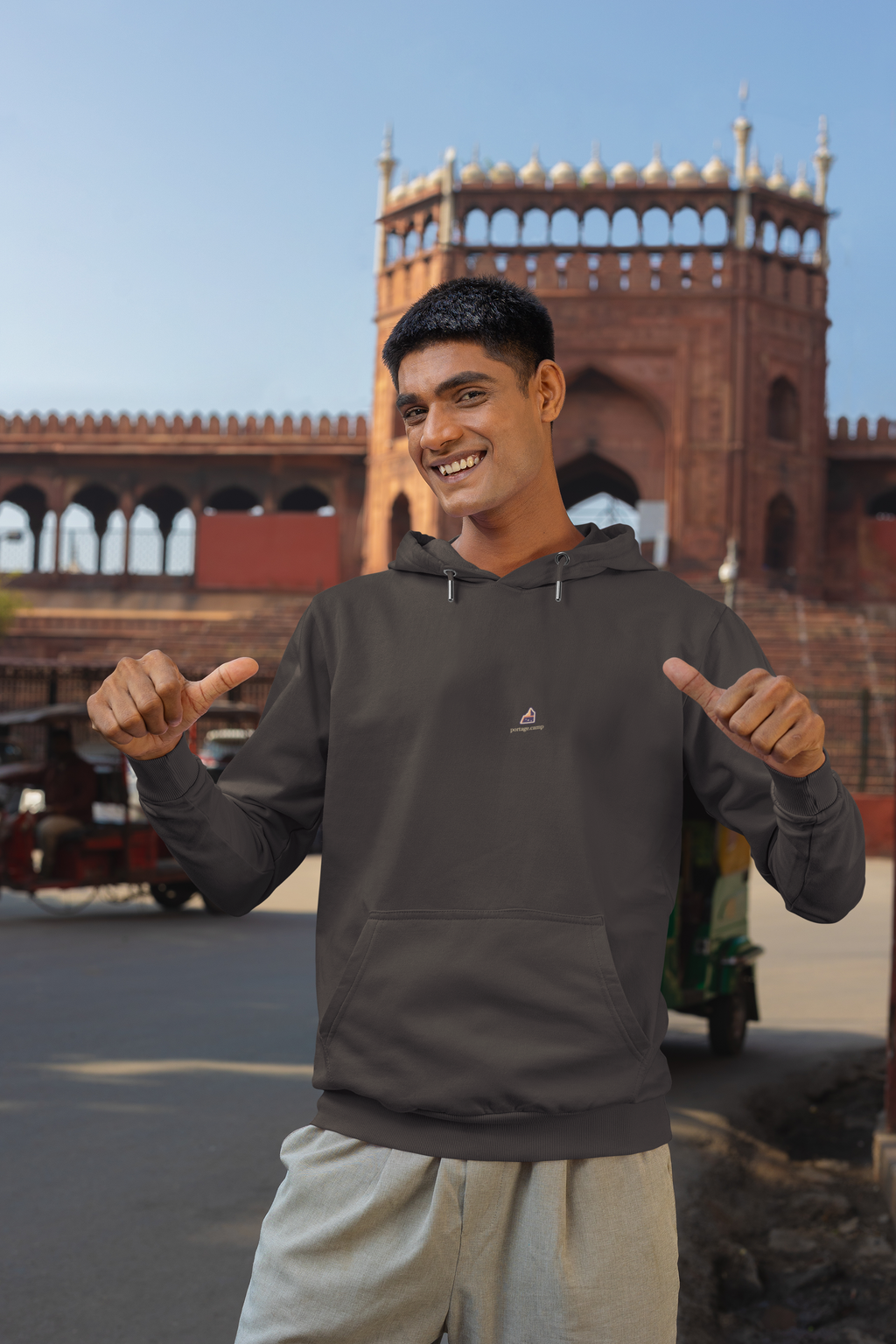 A Different Sky Midweight Hoodie in Black, worn by a man on a city street, with the A Different Sky logo and portage.camp on the chest. Digital product mockup.