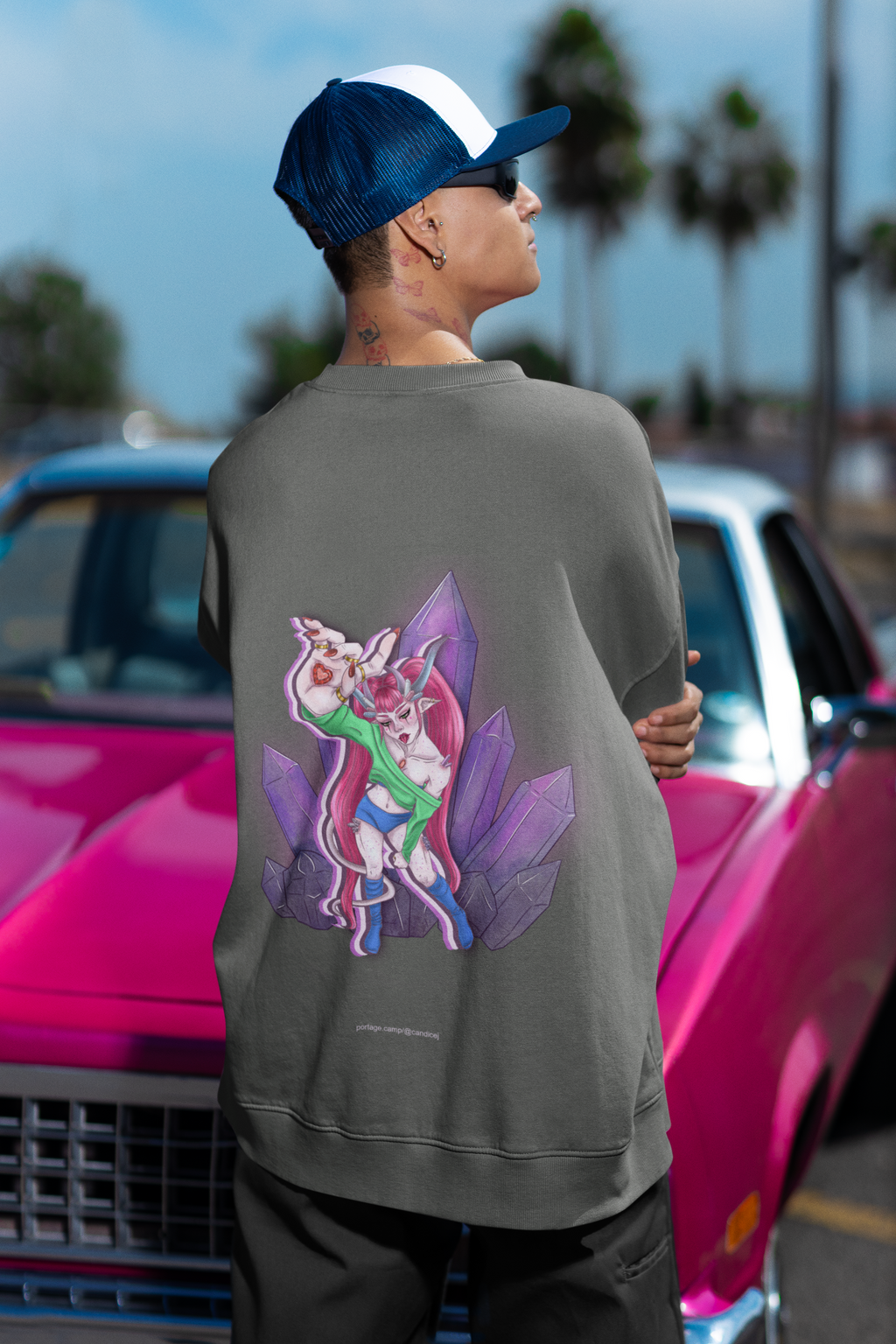 Amethyst After Hours Garment-Dyed Crewneck in Pepper, worn by a man seen from behind by a pink classic car, showing the large print on the back. Digital product mockup.