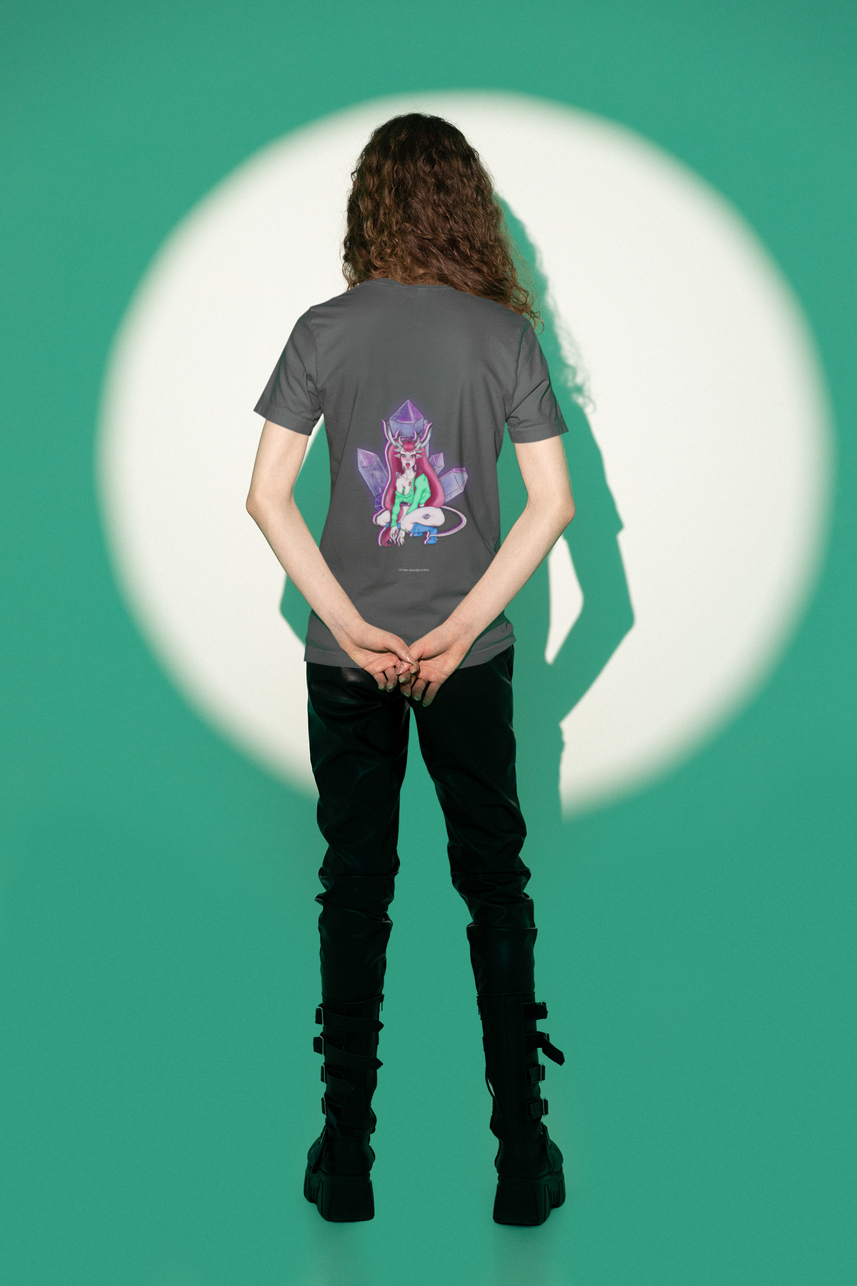 Heart Thief Garment-Dyed Tee in Graphite, worn by a man seen from behind in a studio under green light, showing the large print on the back. Digital product mockup.