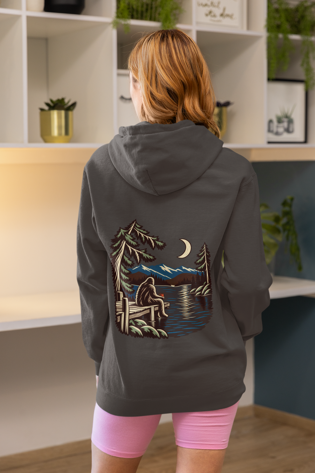 Quiet Hours Zip Hoodie in Dark Heather, worn by a woman seen from behind at home, showing the large print on the back. Digital product mockup.