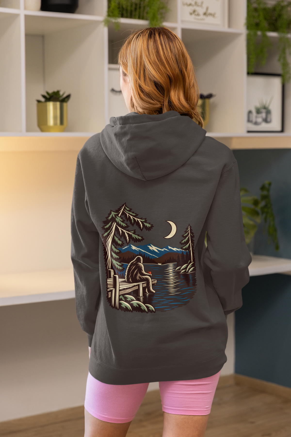 Quiet Hours Zip Hoodie in Dark Heather, worn by a woman seen from behind at home, showing the large print on the back. Digital product mockup.