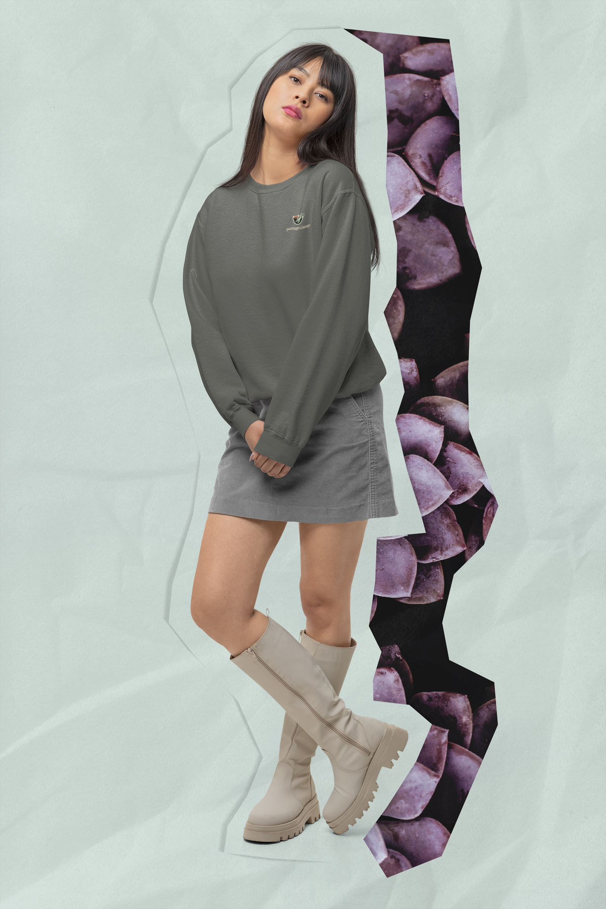 Seen Briefly Garment-Dyed Crewneck in Pepper, worn by a woman in a studio, with the Seen Briefly logo and portage.camp on the chest. Digital product mockup.