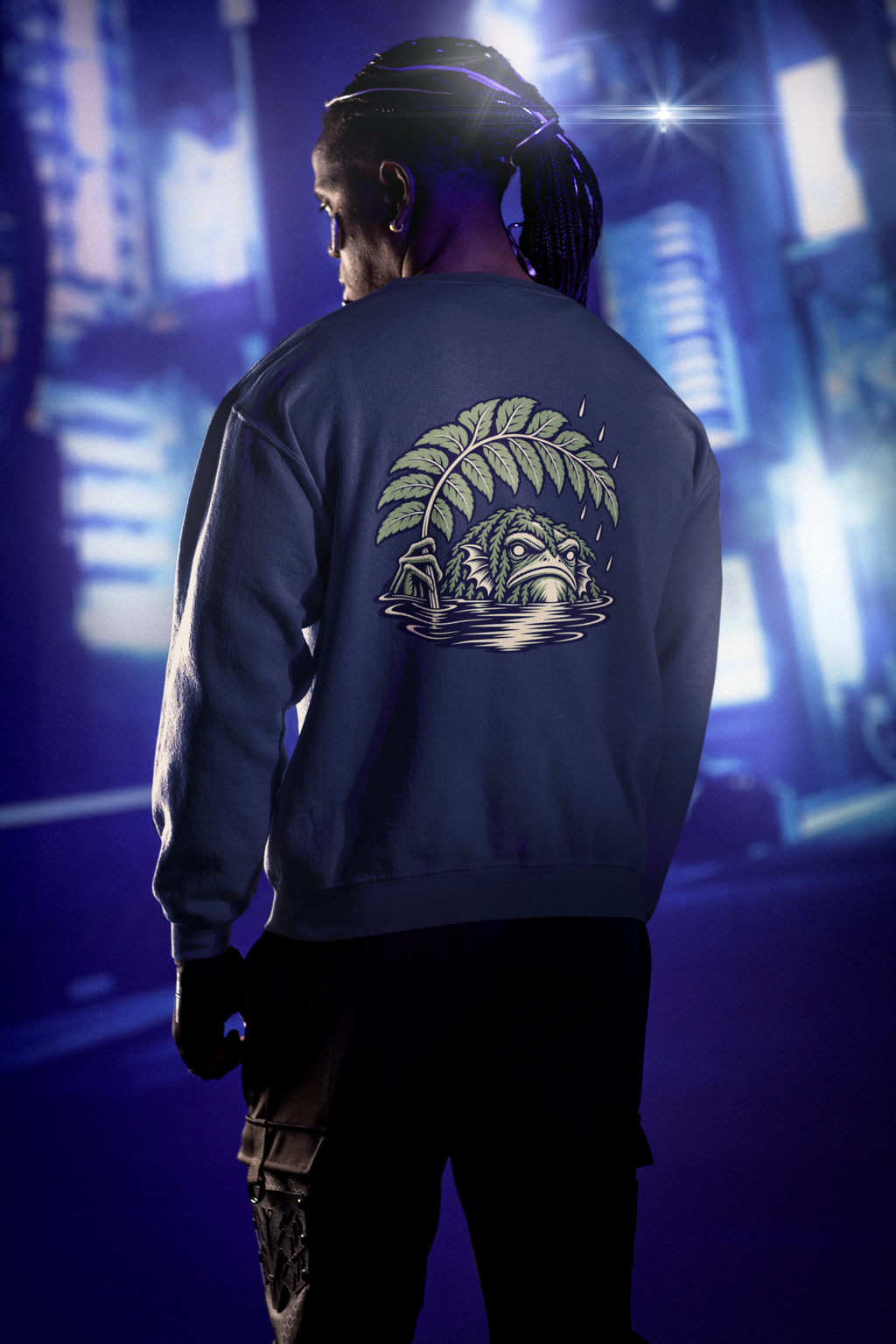 Rain Check Garment-Dyed Crewneck in True Navy, worn by a man seen from behind under neon city lights, showing the large print on the back. Digital product mockup.