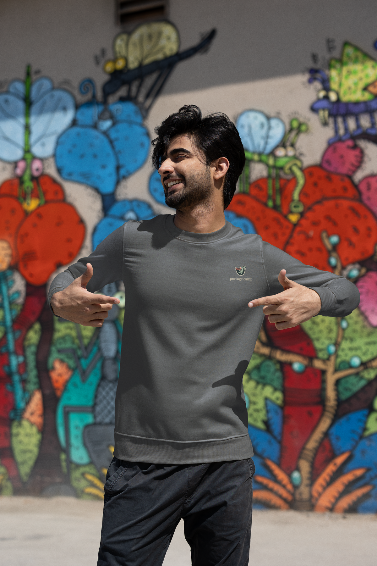 Seen Briefly Garment-Dyed Crewneck in Pepper, worn by a man on a city street, with the Seen Briefly logo and portage.camp on the chest. Digital product mockup.