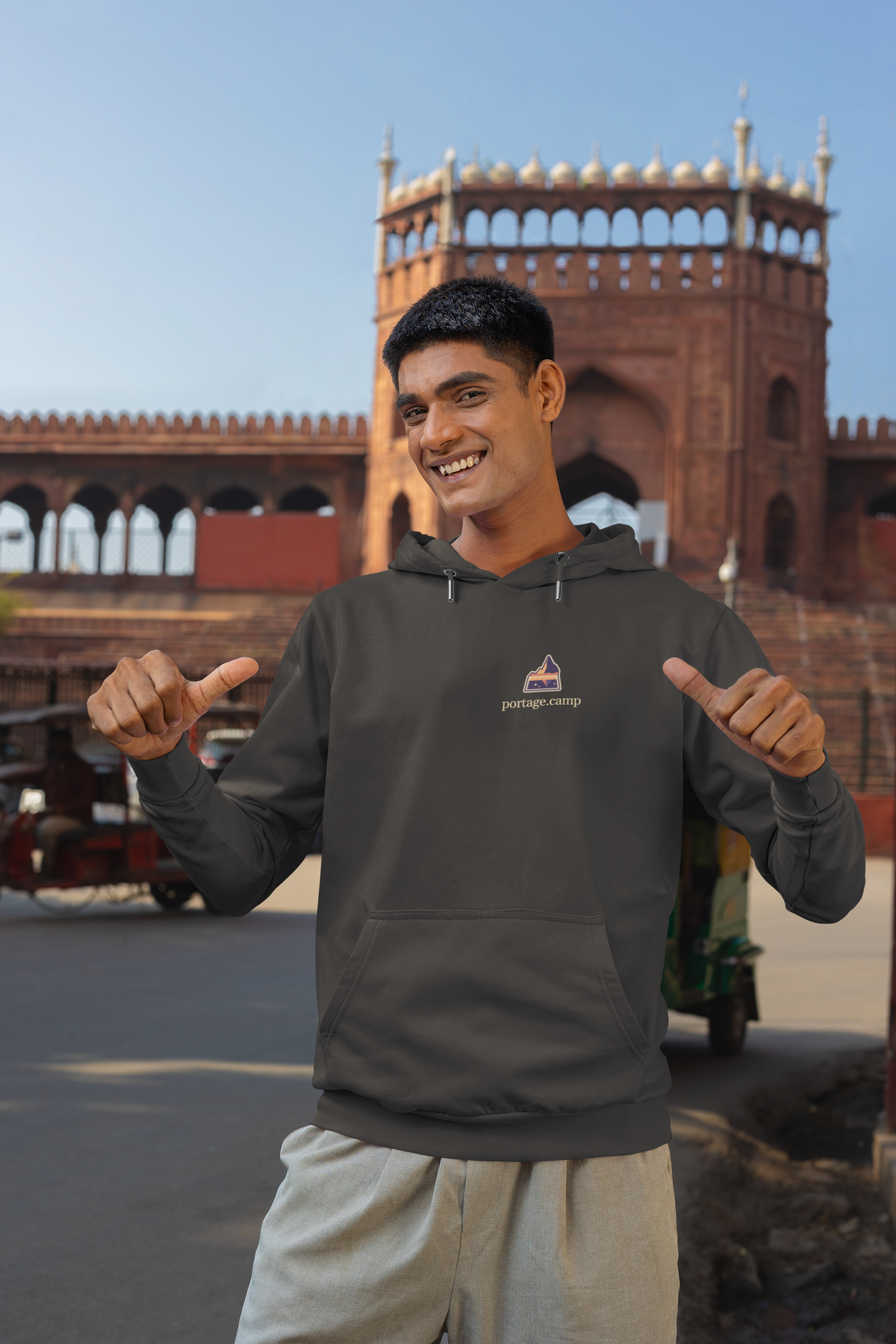 A Different Sky Heavyweight Hoodie in Black, worn by a man on a city street, with the A Different Sky logo and portage.camp on the left chest. Digital product mockup.