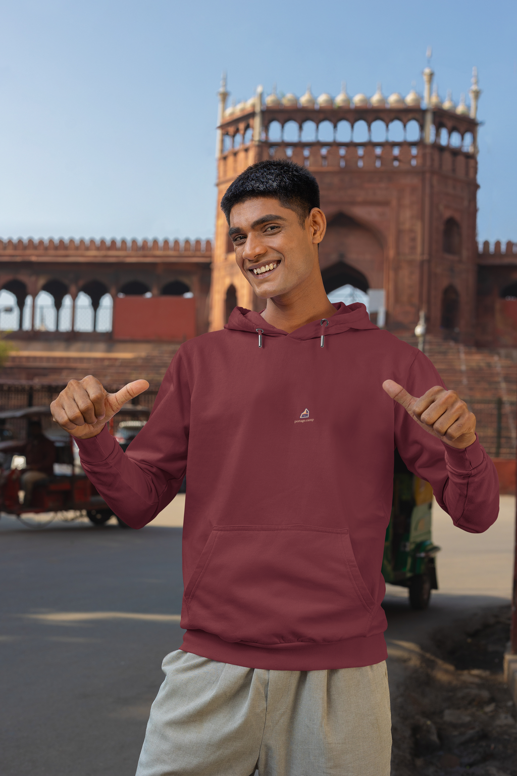 A Different Sky Midweight Hoodie in Maroon, worn by a man on a city street, with the A Different Sky logo and portage.camp on the chest. Digital product mockup.