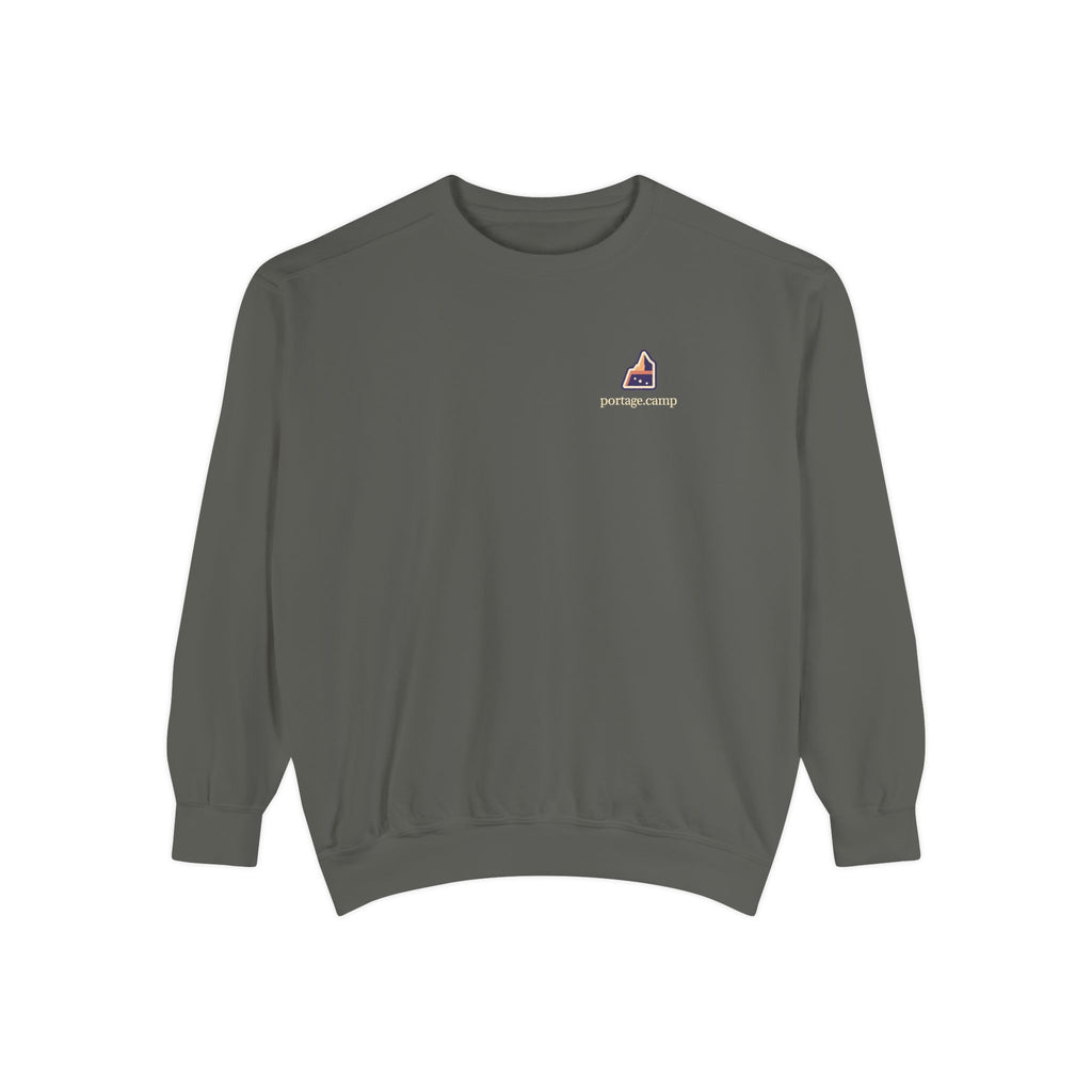 A Different Sky Garment-Dyed Crewneck in Pepper, front view with the A Different Sky logo and portage.camp on the chest. Digital product mockup.