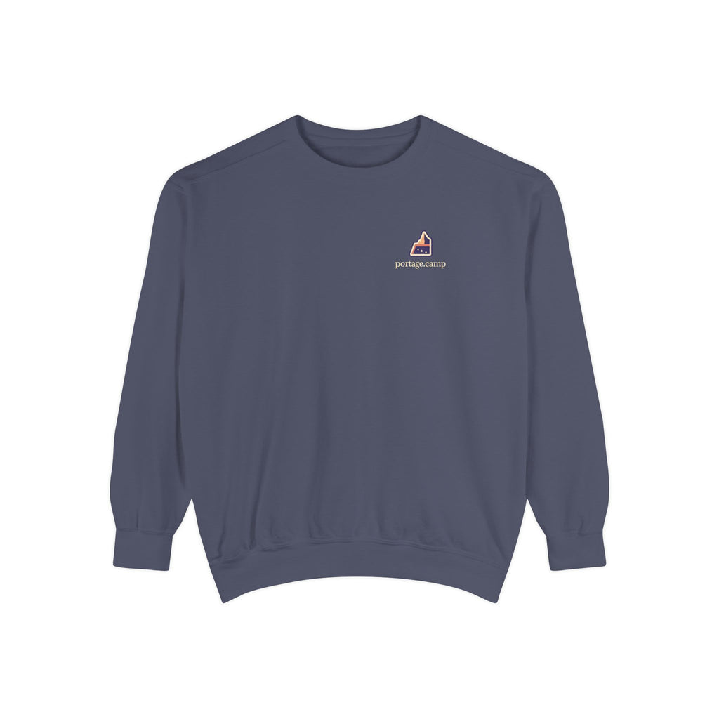 A Different Sky Garment-Dyed Crewneck in Denim, front view with the A Different Sky logo and portage.camp on the chest. Digital product mockup.