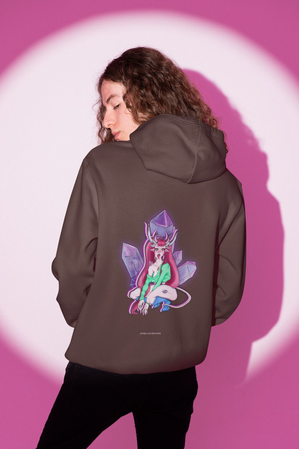 Heart Thief Heavyweight Hoodie in Brown, worn by a man seen from behind in a studio under pink light, showing the large print on the back. Digital product mockup.