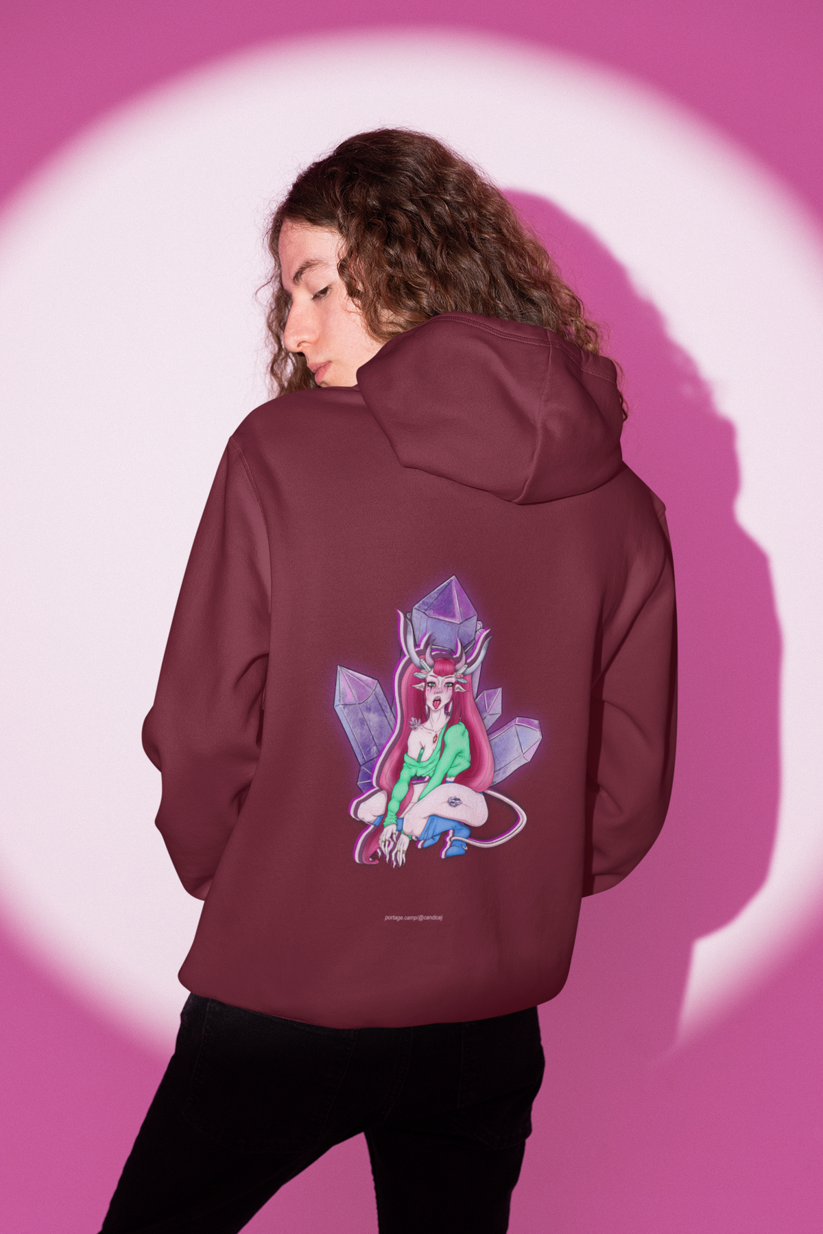 Heart Thief Midweight Hoodie in Maroon, worn by a man seen from behind in a studio under pink light, showing the large print on the back. Digital product mockup.