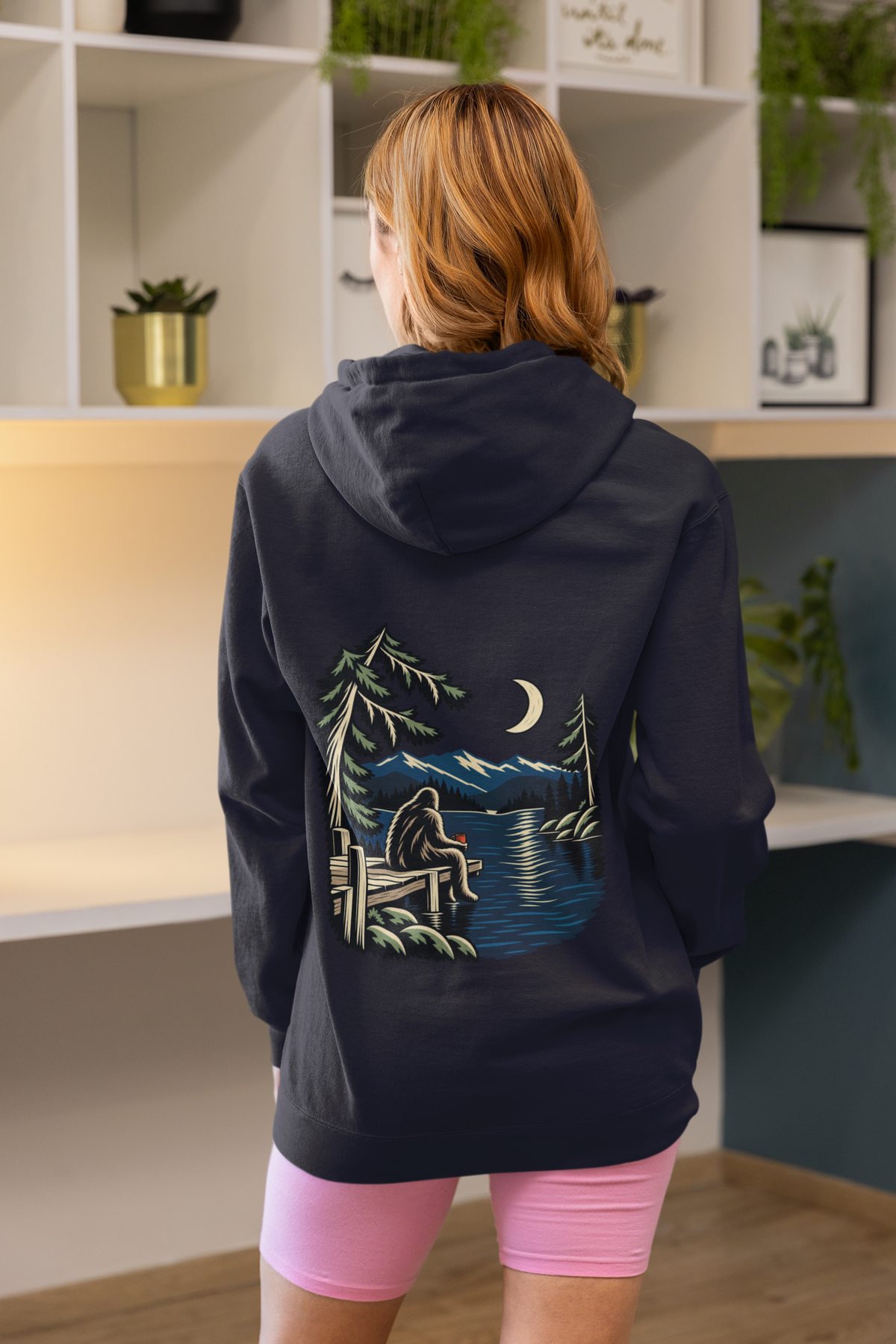 Quiet Hours Zip Hoodie in Navy, worn by a woman seen from behind at home, showing the large print on the back. Digital product mockup.