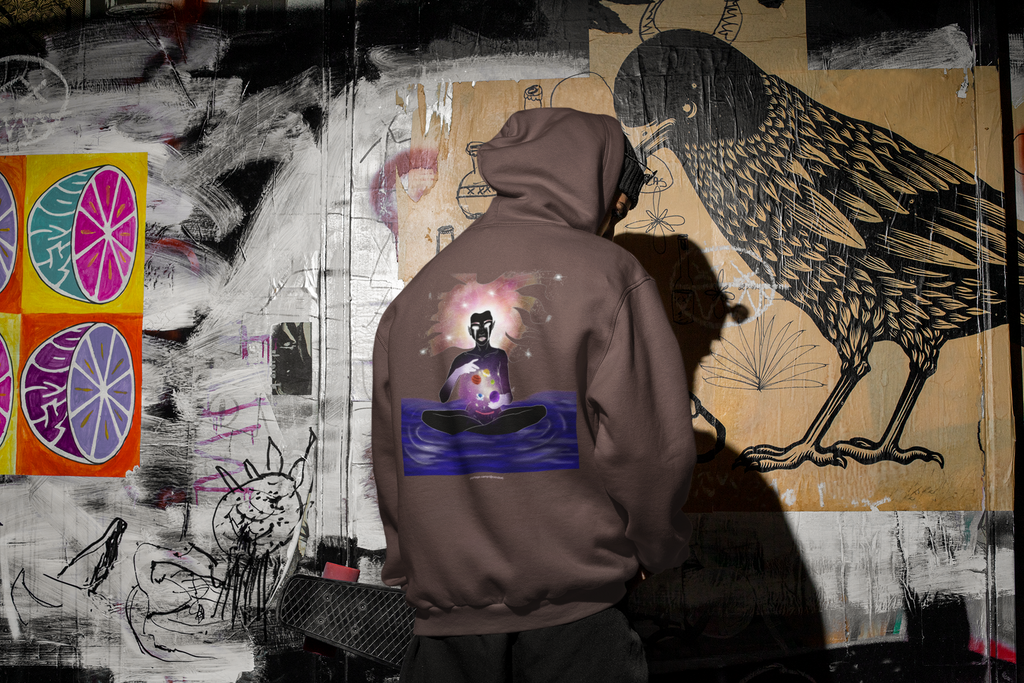 Orbit Keeper Heavyweight Hoodie in Brown, worn by a man seen from behind in a dark alley, showing the large print on the back. Digital product mockup.