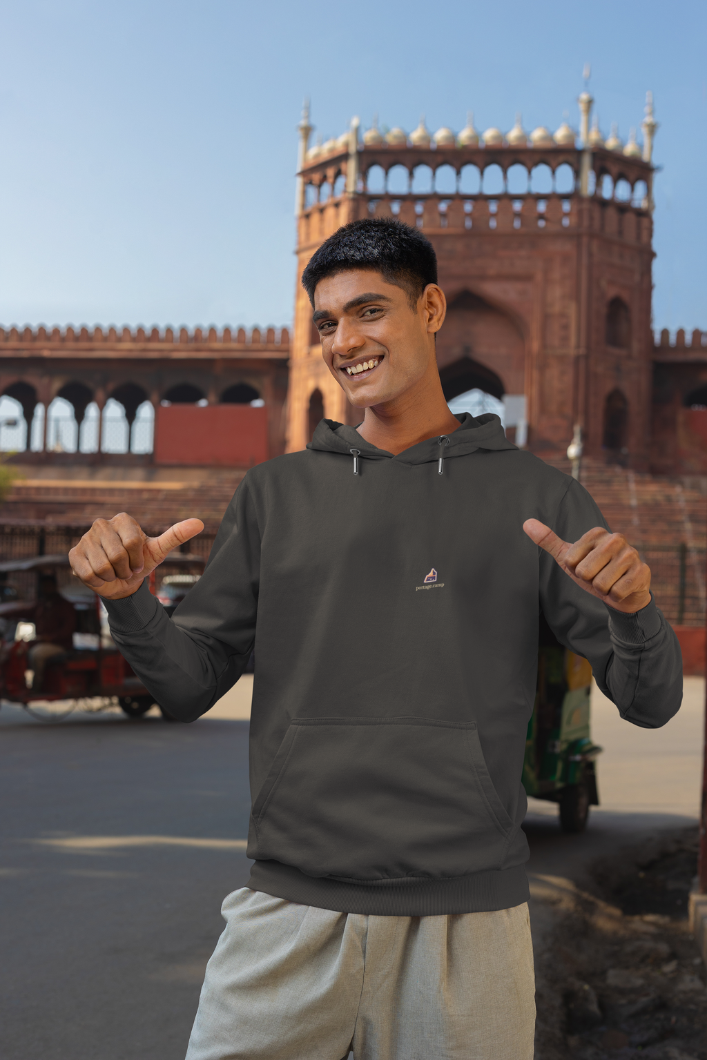 A Different Sky Heavyweight Hoodie in Black, worn by a man on a city street, with the A Different Sky logo and portage.camp on the left chest. Digital product mockup.