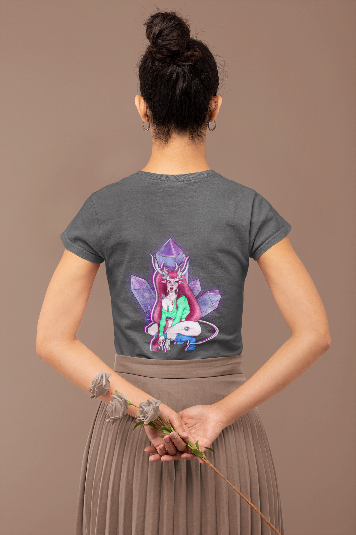 Heart Thief Garment-Dyed Tee in Graphite, worn by a woman seen from behind holding flowers, showing the large print on the back. Digital product mockup.