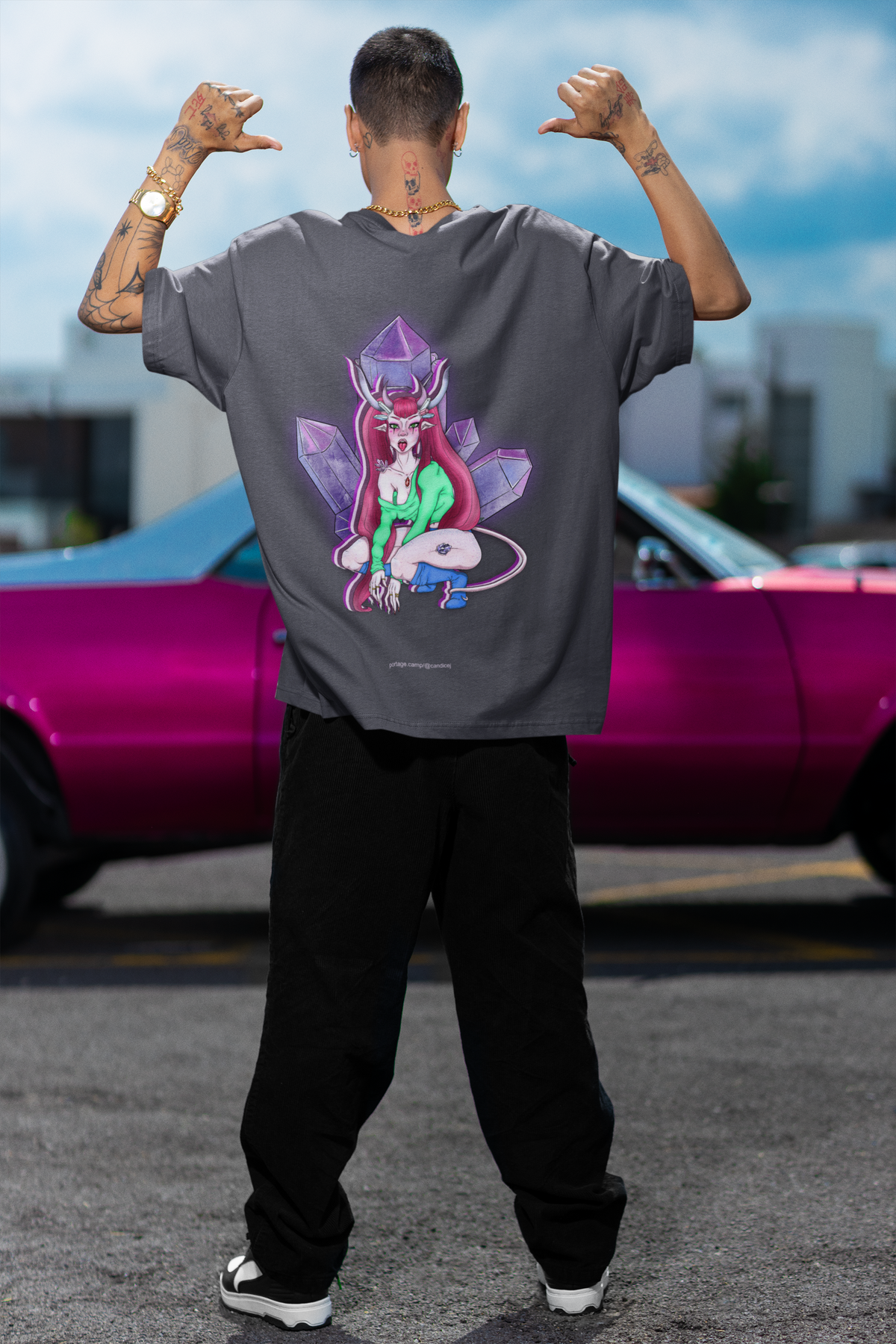 Amethyst After Hours Garment-Dyed Tee in Navy, worn by a man seen from behind by a pink car, showing the large print on the back. Digital product mockup.