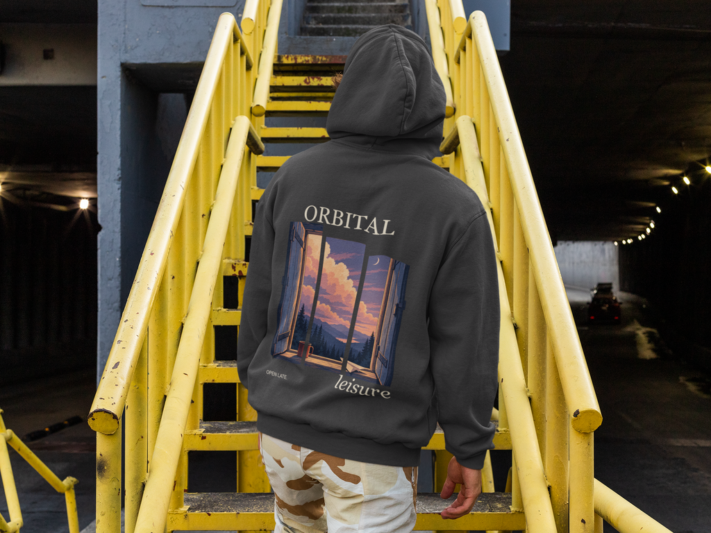 Cloud Ferry Heavyweight Hoodie in Black, worn by a man seen from behind climbing a yellow metal staircase, showing the large print on the back. Digital product mockup.