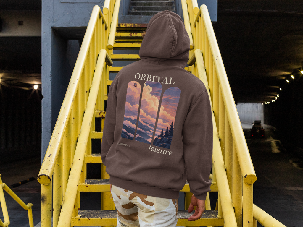 Cloud Ferry Heavyweight Hoodie in Brown, worn by a man seen from behind climbing a yellow metal staircase, showing the large print on the back. Digital product mockup.