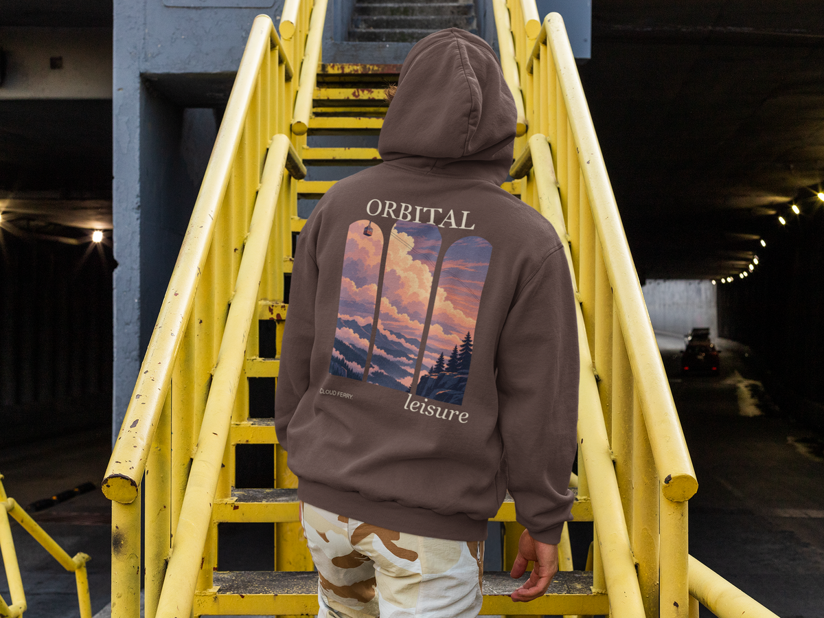 Cloud Ferry Heavyweight Hoodie in Brown, worn by a man seen from behind climbing a yellow metal staircase, showing the large print on the back. Digital product mockup.