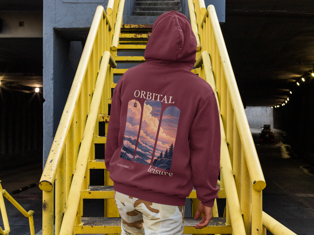 Cloud Ferry Midweight Hoodie in Maroon, worn by a man seen from behind climbing a yellow metal staircase, showing the large print on the back. Digital product mockup.