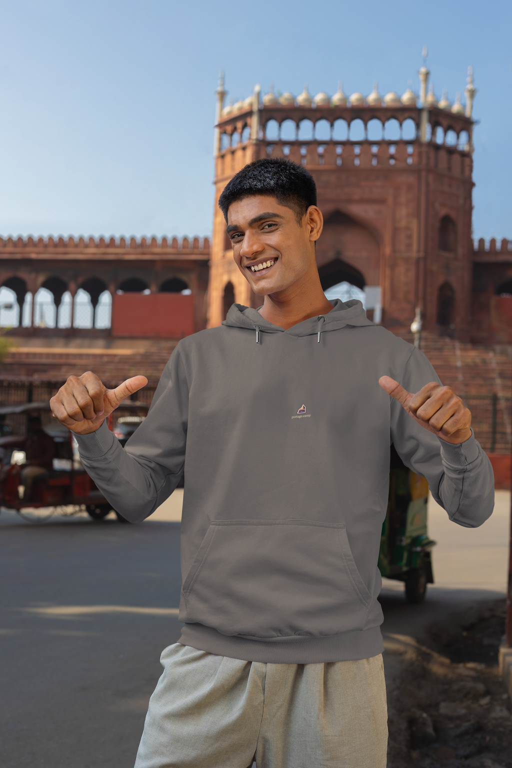 A Different Sky Midweight Hoodie in Charcoal, worn by a man on a city street, with the A Different Sky logo and portage.camp on the chest. Digital product mockup.