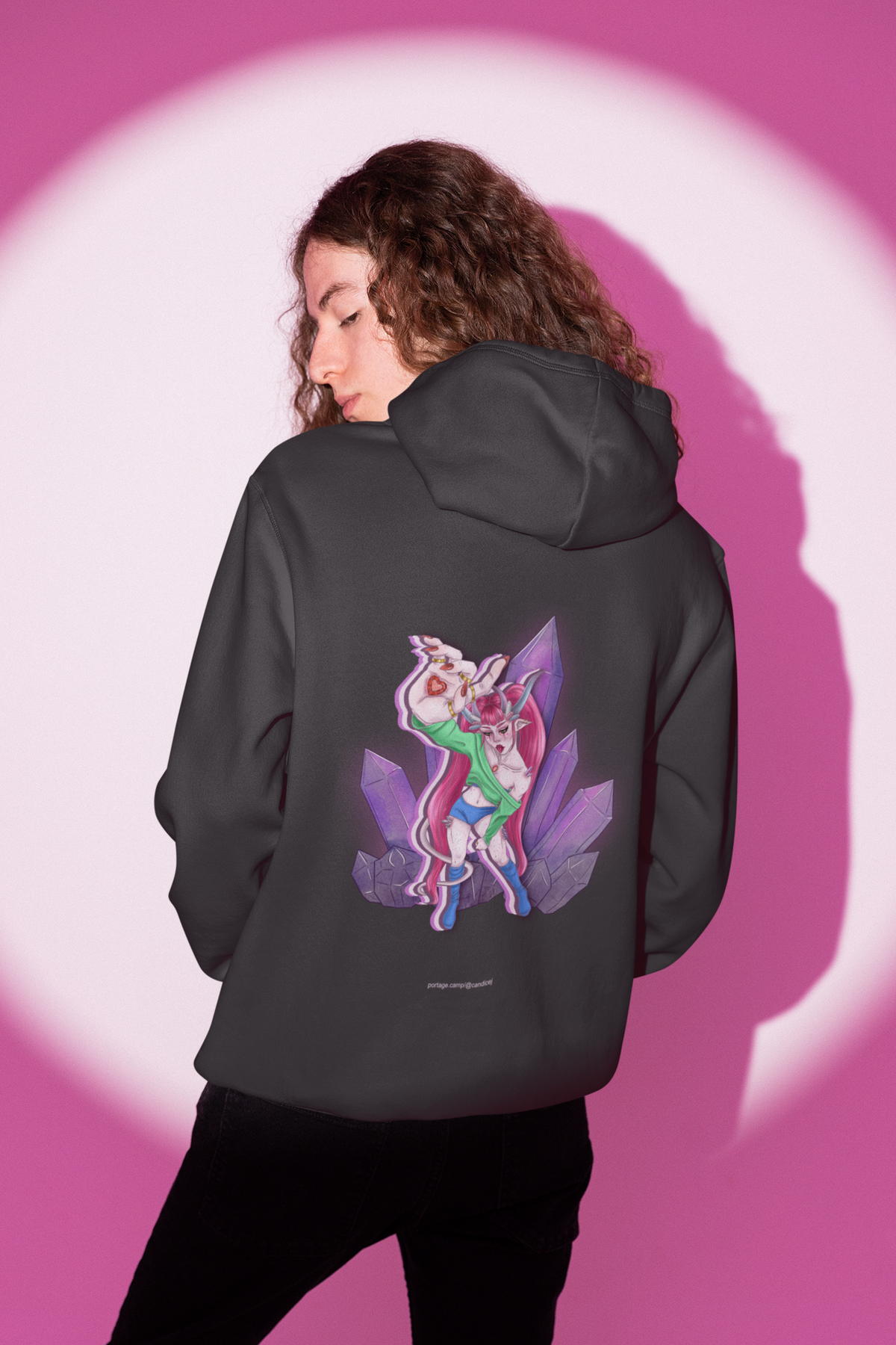 Heart Thief Heavyweight Hoodie in Black, worn by a man seen from behind in a studio under pink light, showing the large print on the back. Digital product mockup.