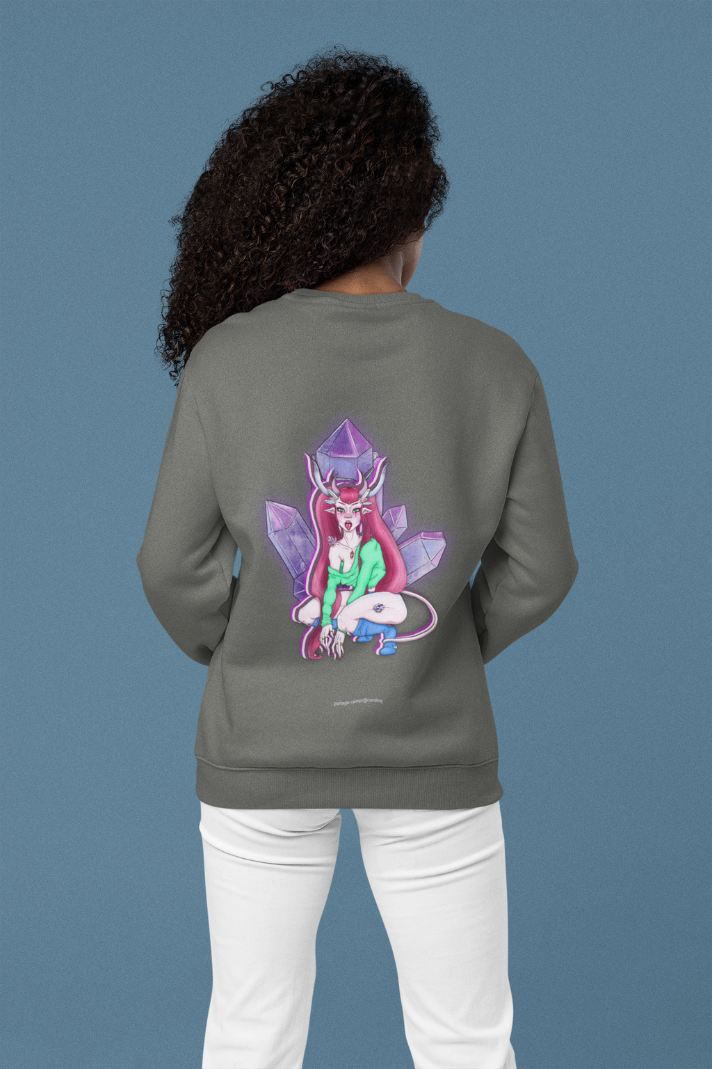 Heart Thief Garment-Dyed Crewneck in Pepper, worn by a woman seen from behind in a studio, showing the large print on the back. Digital product mockup.