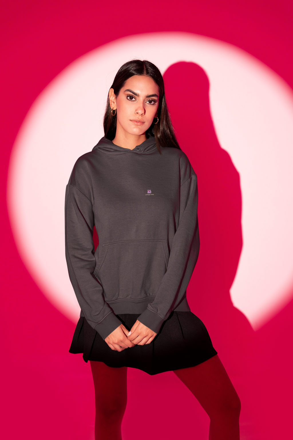 Amethyst After Hours Heavyweight Hoodie in Black, worn by a woman in a red-lit studio, with the Amethyst After Hours logo and portage.camp on the left chest. Digital product mockup.