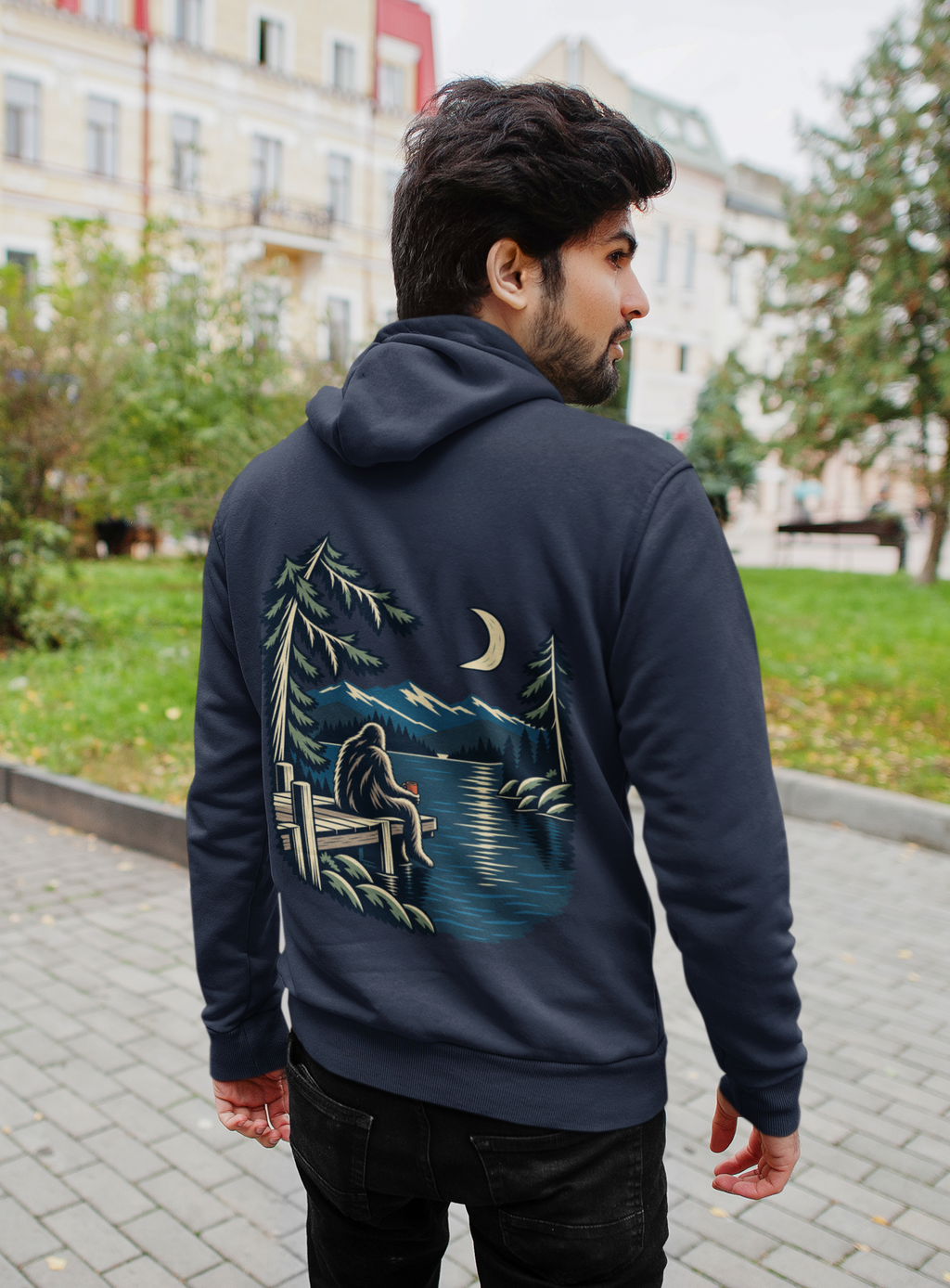 Quiet Hours Zip Hoodie in Navy, worn by a man seen from behind on a quiet city street, showing the large print on the back. Digital product mockup.