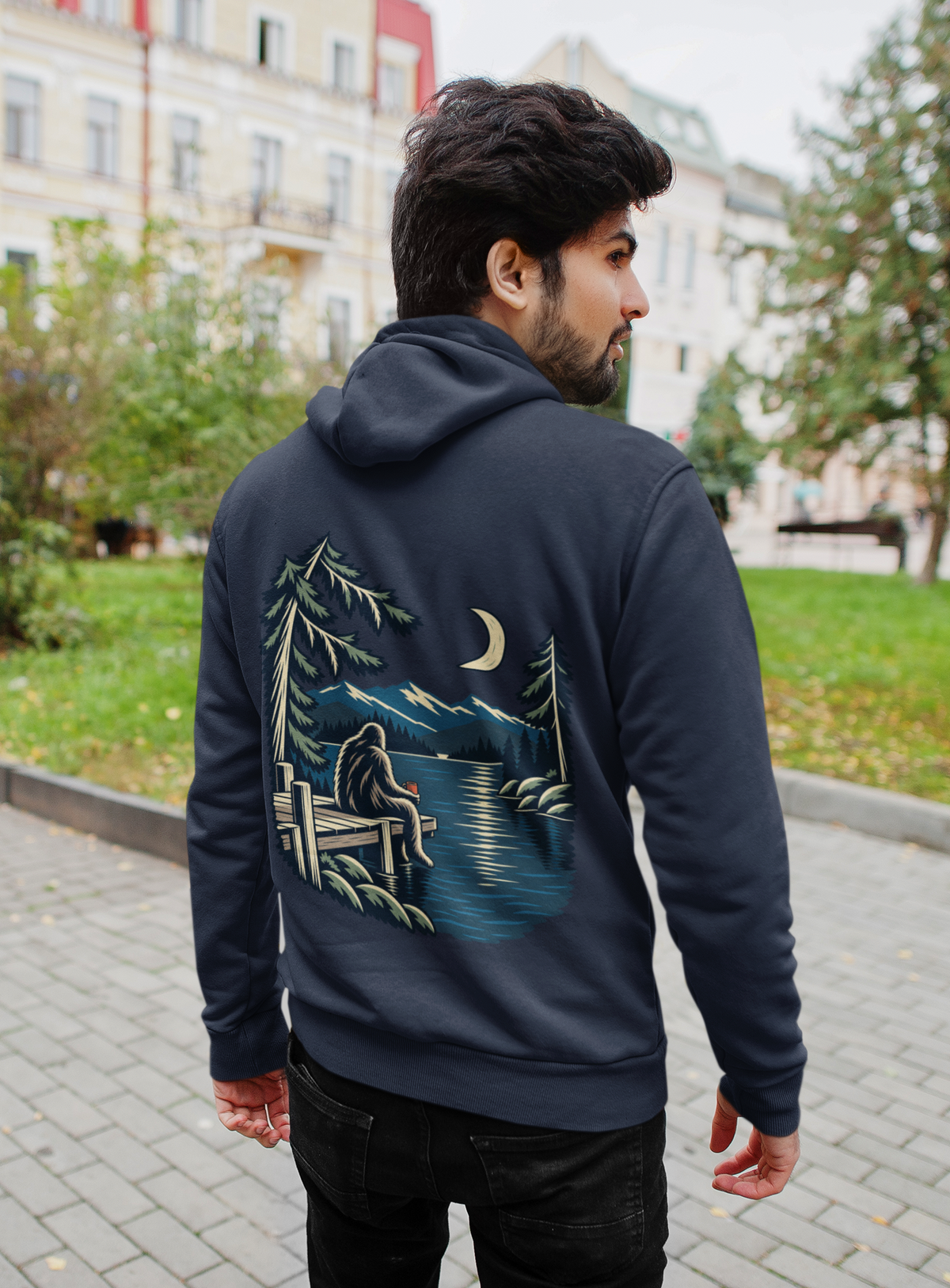 Quiet Hours Zip Hoodie in Navy, worn by a man seen from behind on a quiet city street, showing the large print on the back. Digital product mockup.