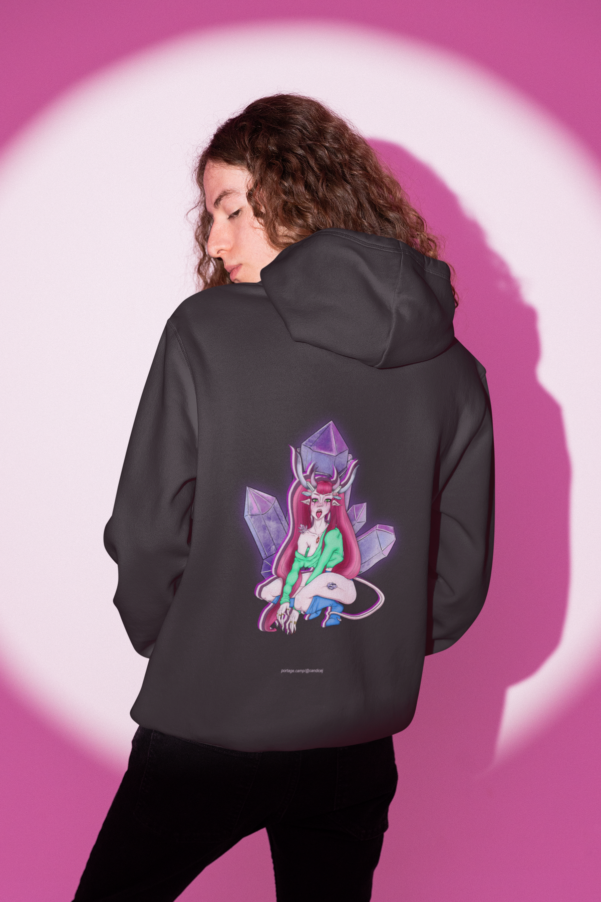 Heart Thief Midweight Hoodie in Black, worn by a man seen from behind in a studio under pink light, showing the large print on the back. Digital product mockup.