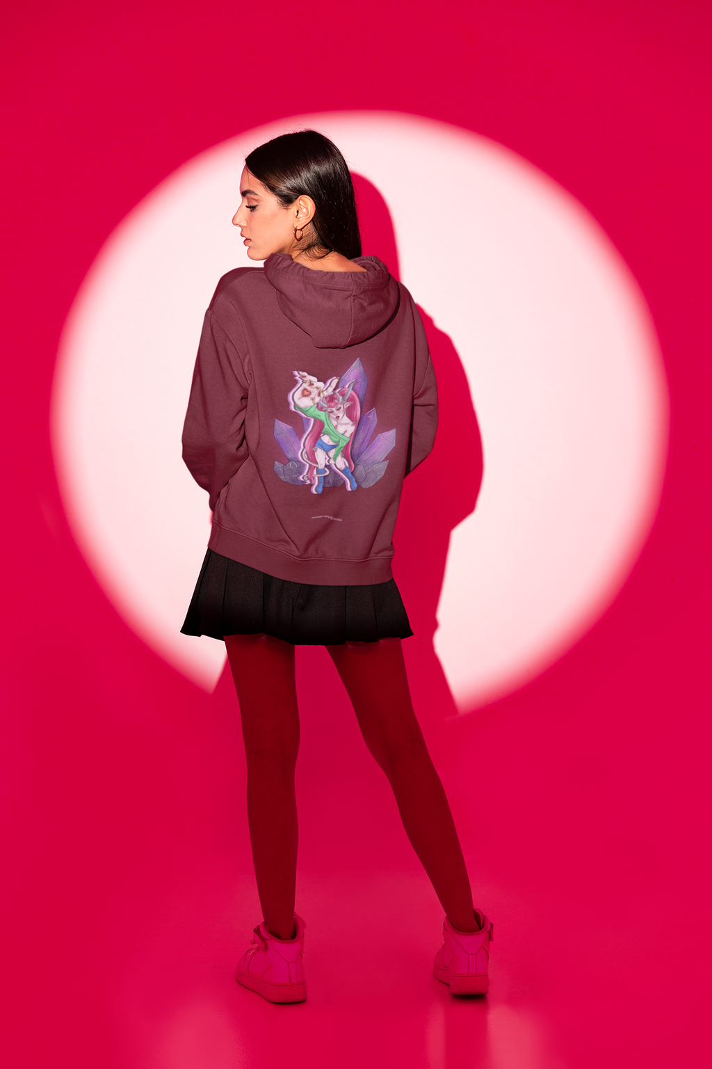 Amethyst After Hours Midweight Hoodie in Maroon, worn by a woman seen from behind in a studio spotlight, showing the large print on the back. Digital product mockup.