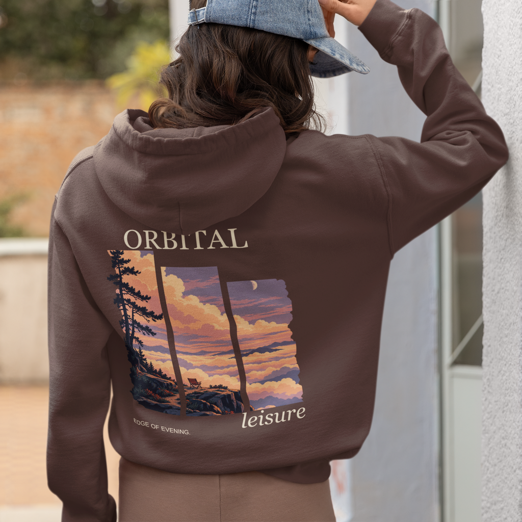 A Different Sky Heavyweight Hoodie in Brown, worn by a woman seen from behind at home, showing the large print on the back. Digital product mockup.