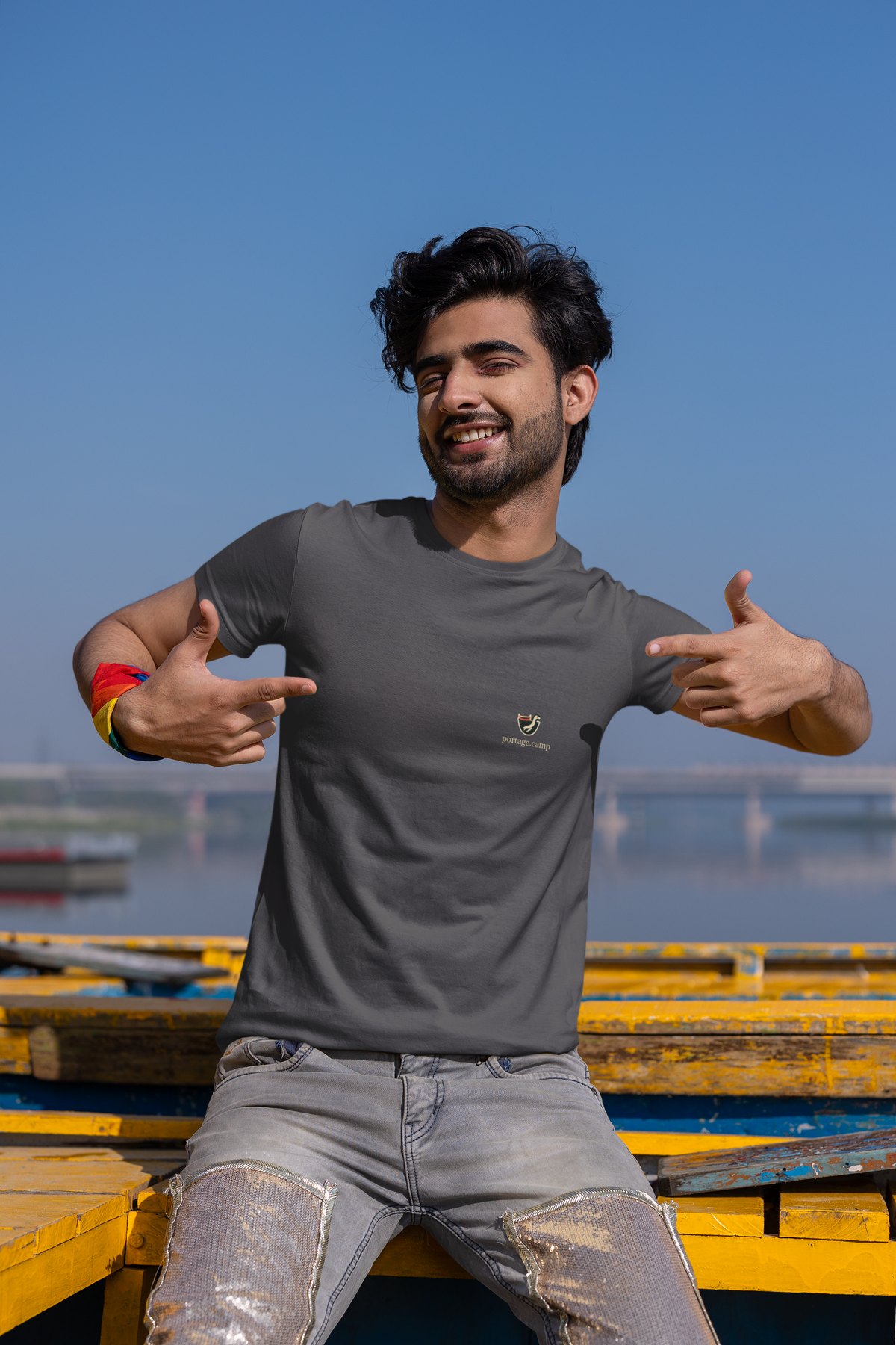 Seen Briefly Garment-Dyed Tee in Navy, worn by a man on a city street, with the Seen Briefly logo and portage.camp on the chest. Digital product mockup.