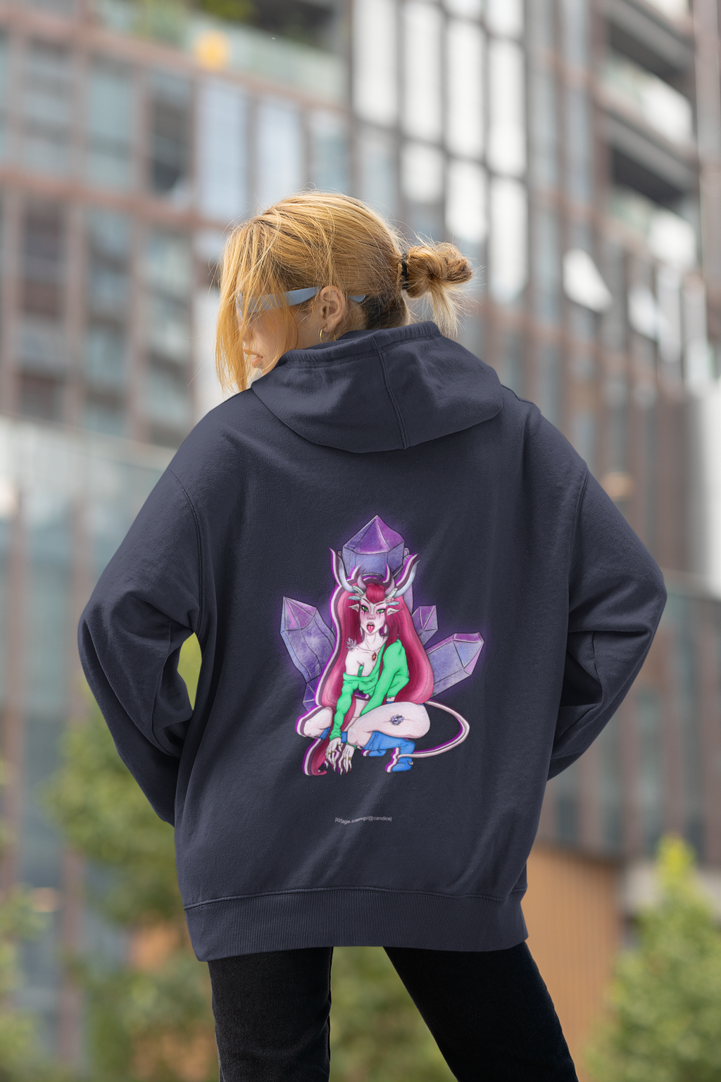 Heart Thief Midweight Hoodie in Classic Navy, worn by a woman seen from behind by tall city buildings, showing the large print on the back. Digital product mockup.